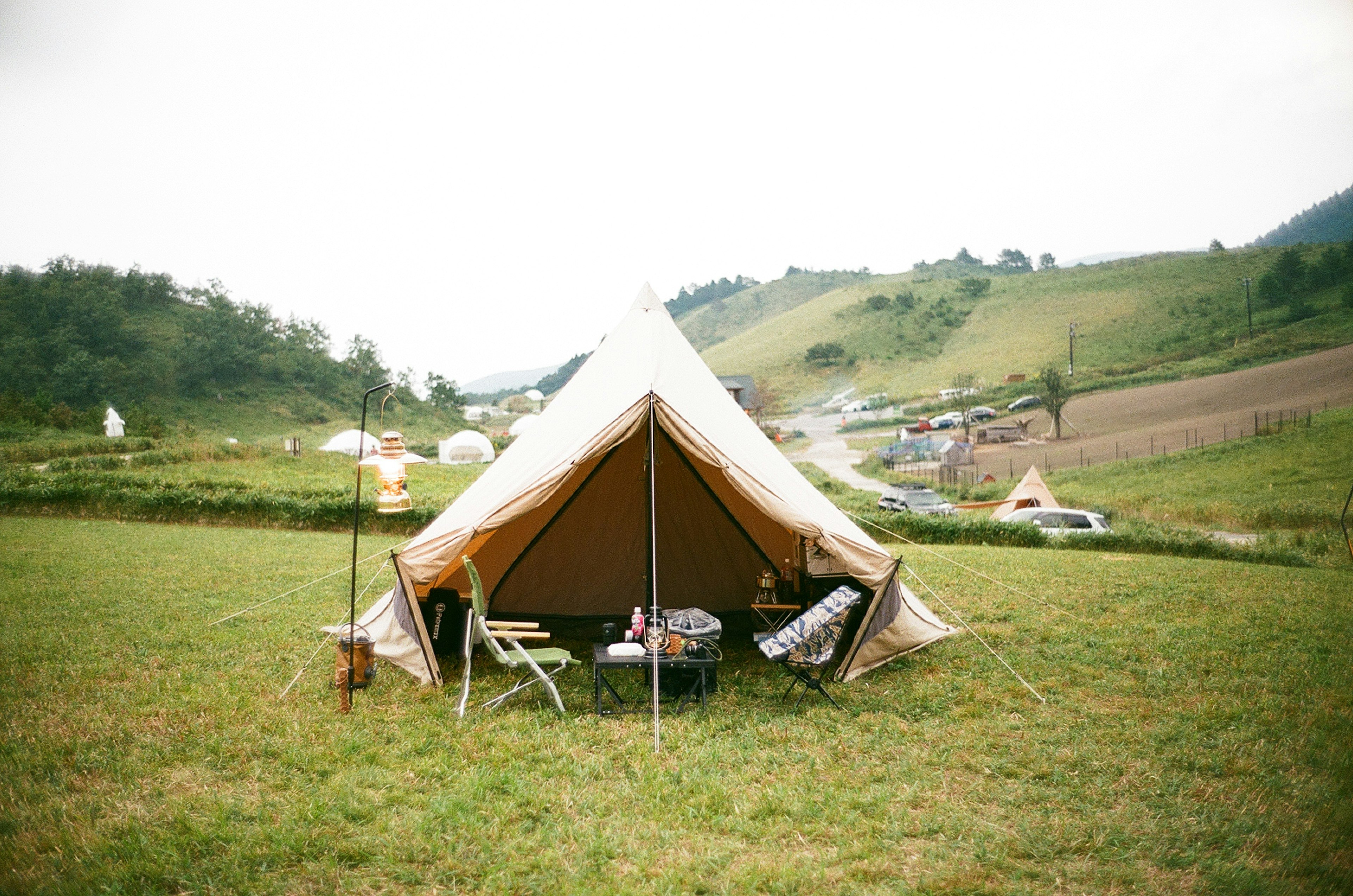 Large tent set up in a green meadow