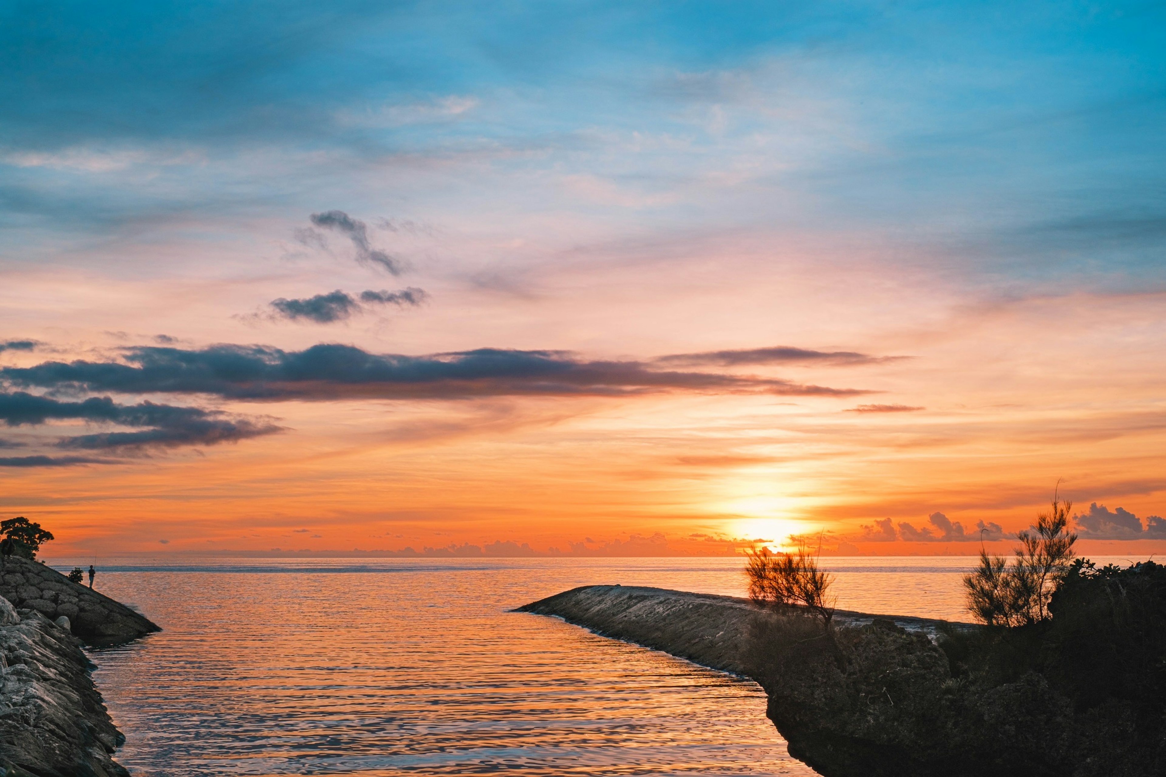 Vue côtière magnifique avec un coucher de soleil sur des eaux calmes