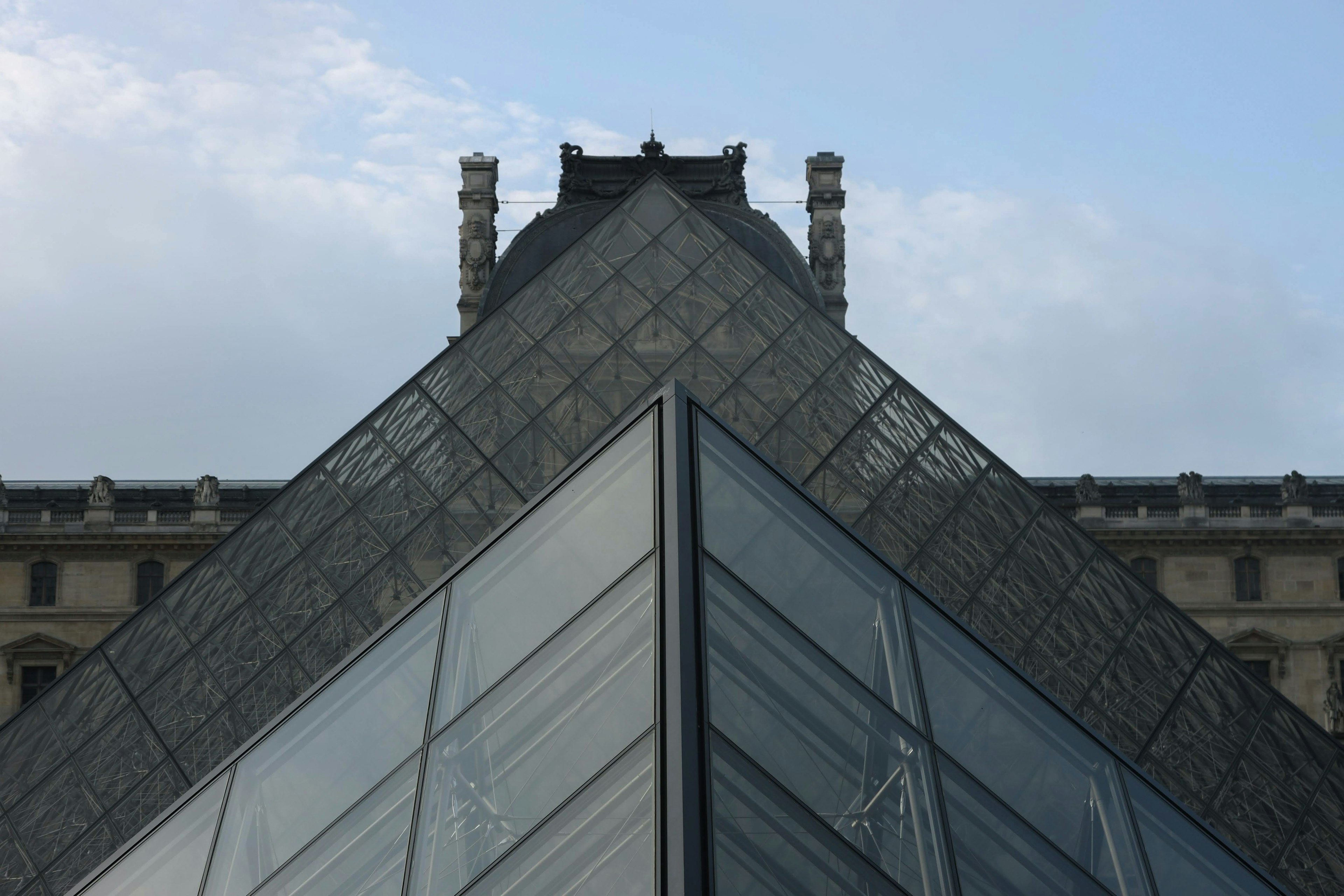 View of the top angle of the glass pyramid at the Louvre Museum