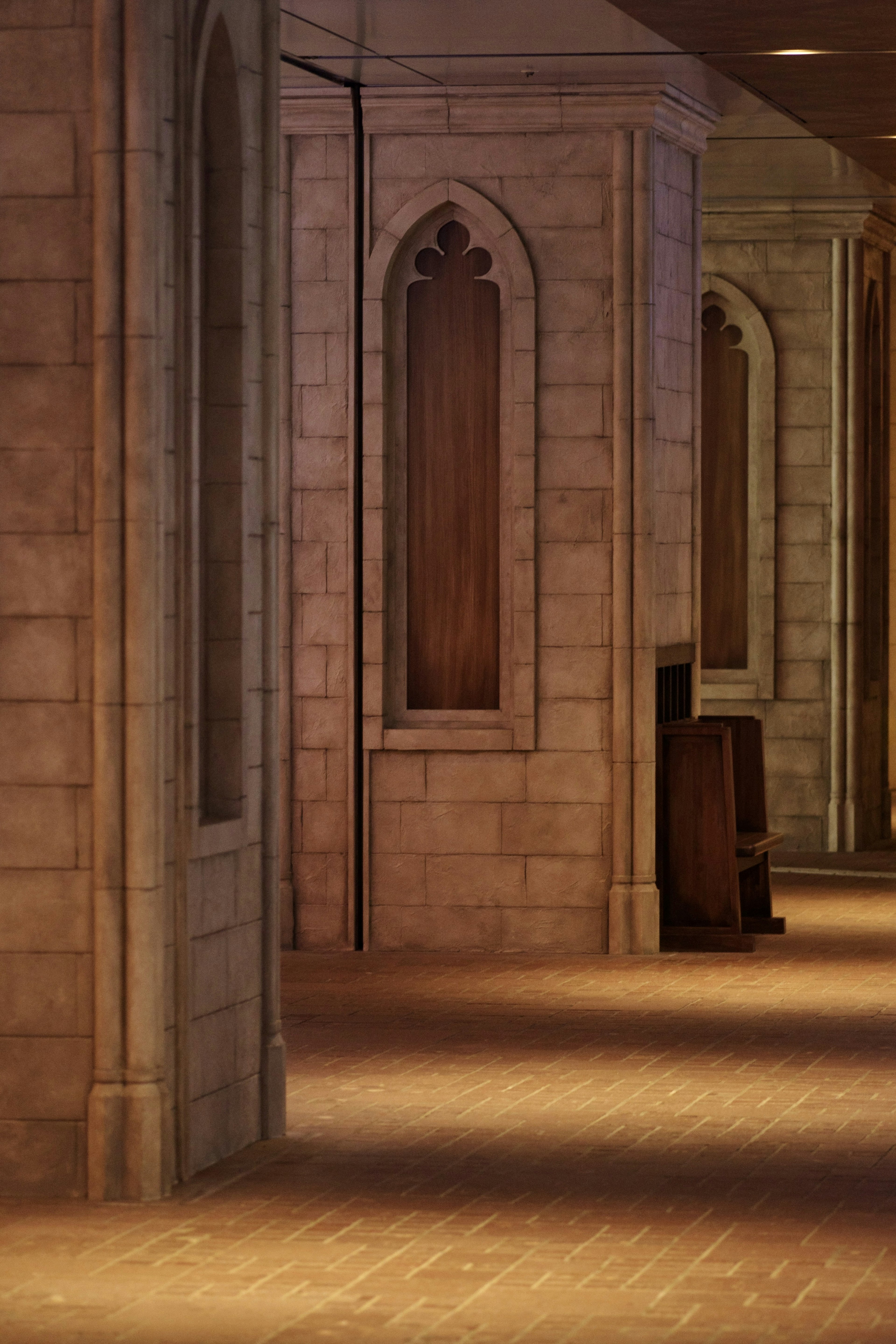 Interior hallway with stone walls and arched windows