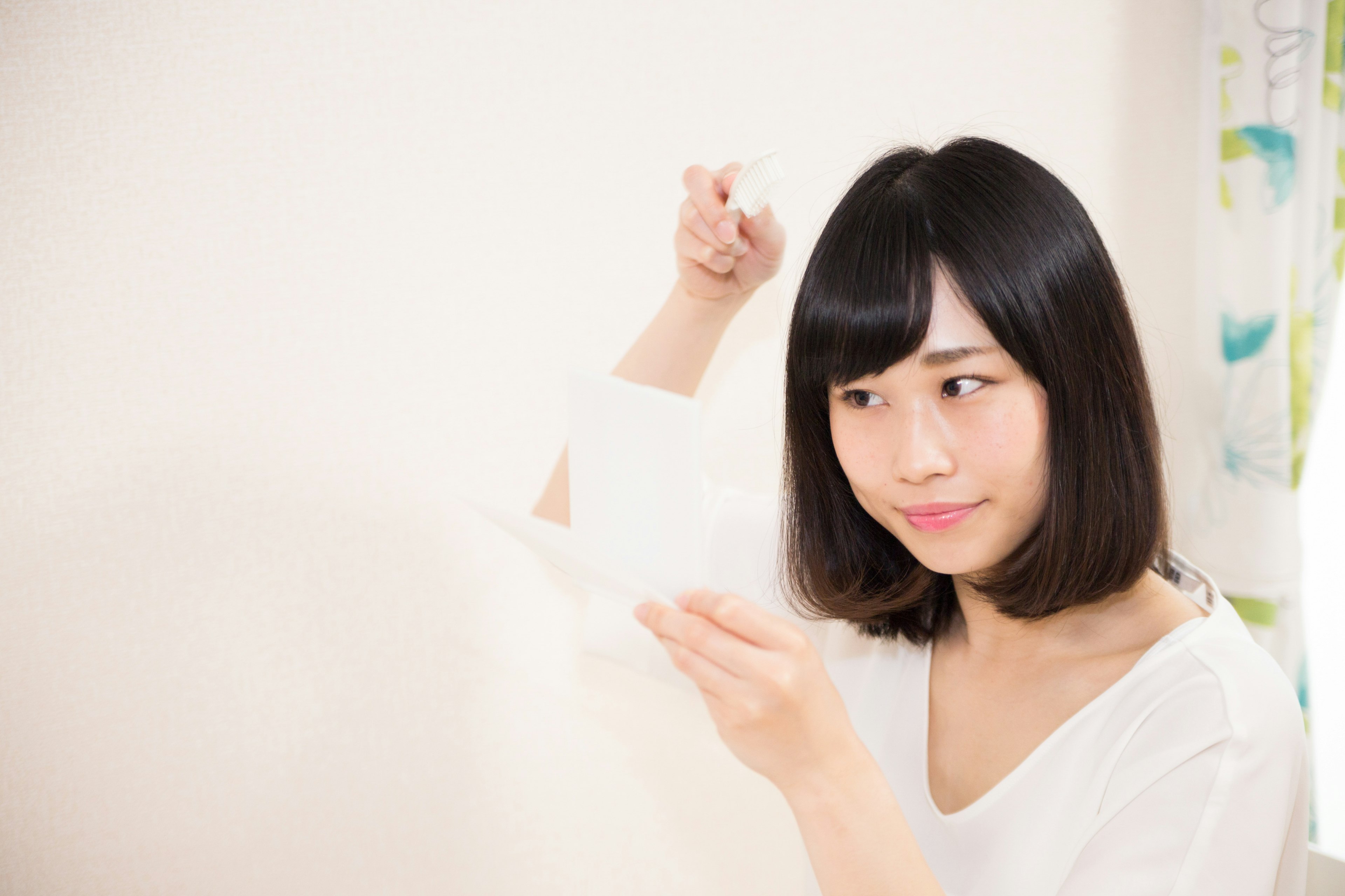 A woman focused on holding a piece of white paper