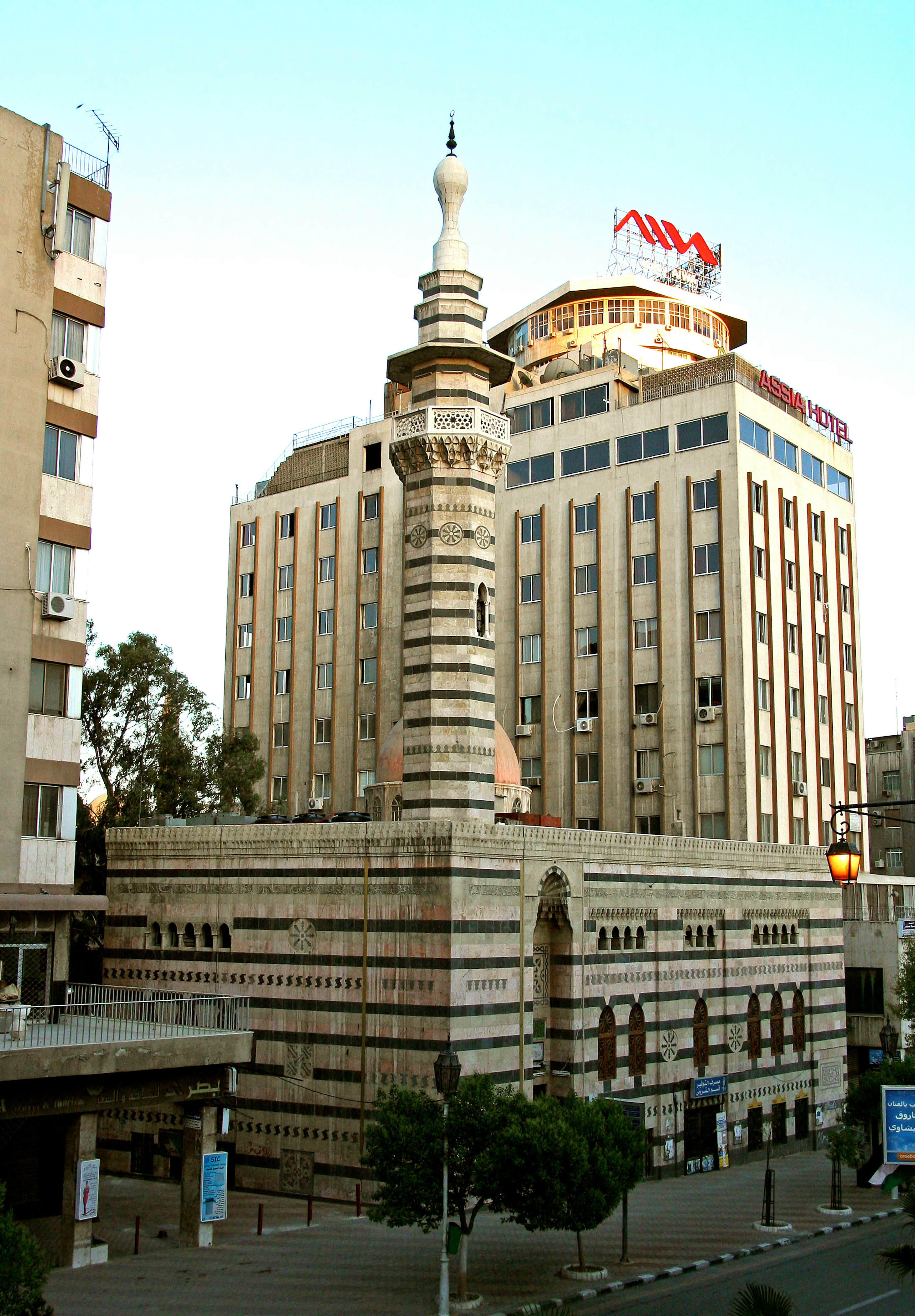 Cityscape featuring a mosque and modern buildings