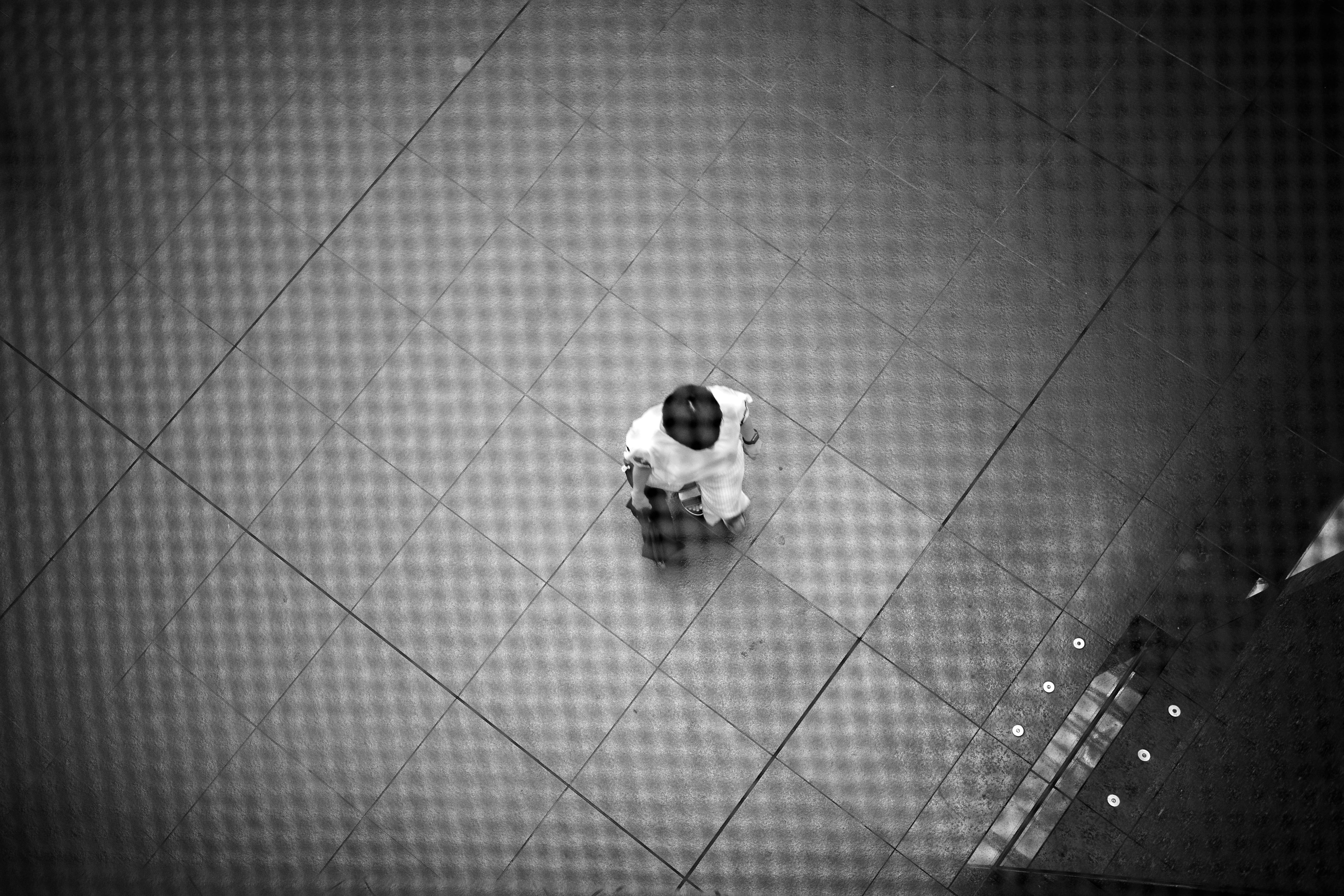 A black and white image of a child sitting in the center