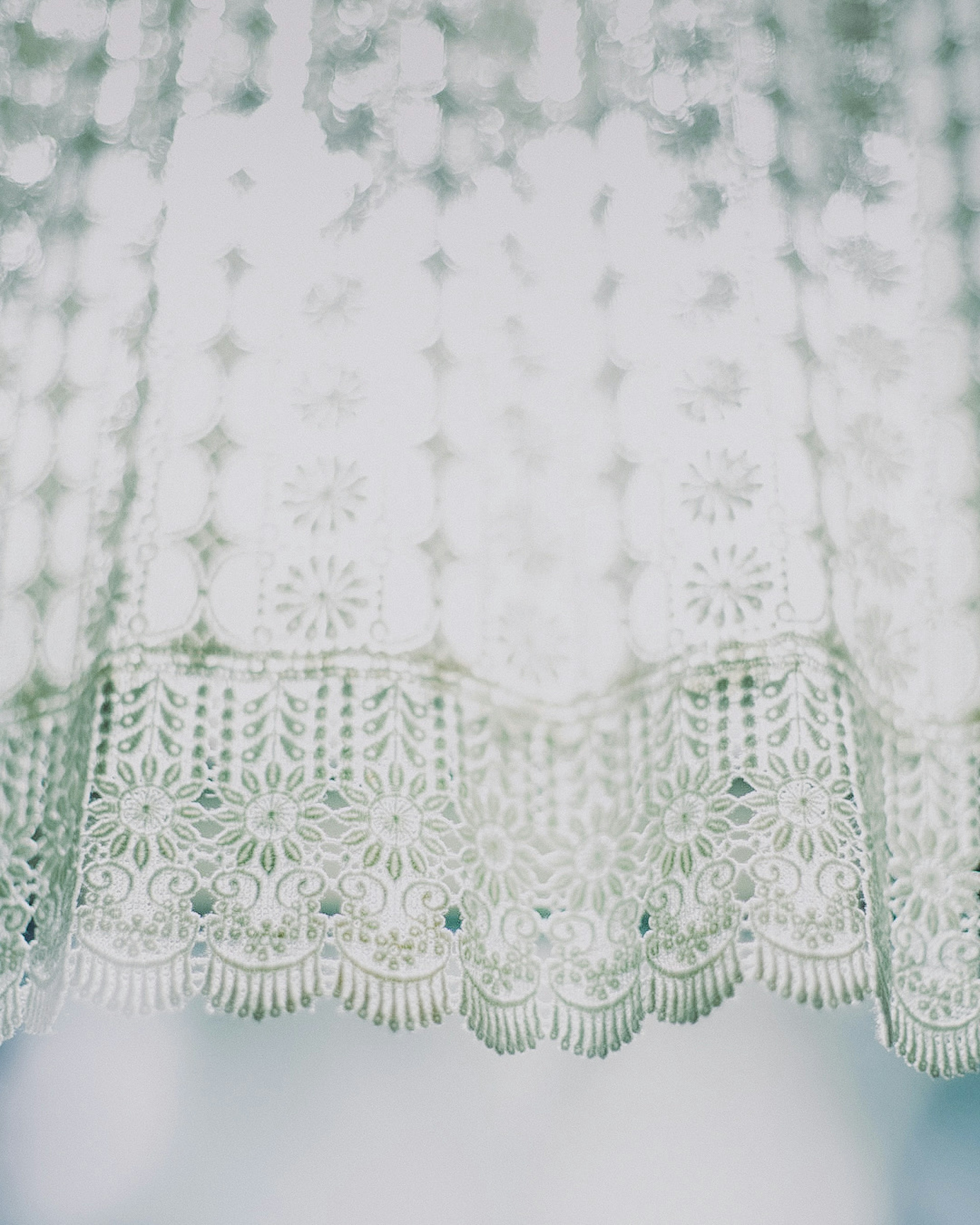 Detailed texture and pattern of a sheer lace curtain