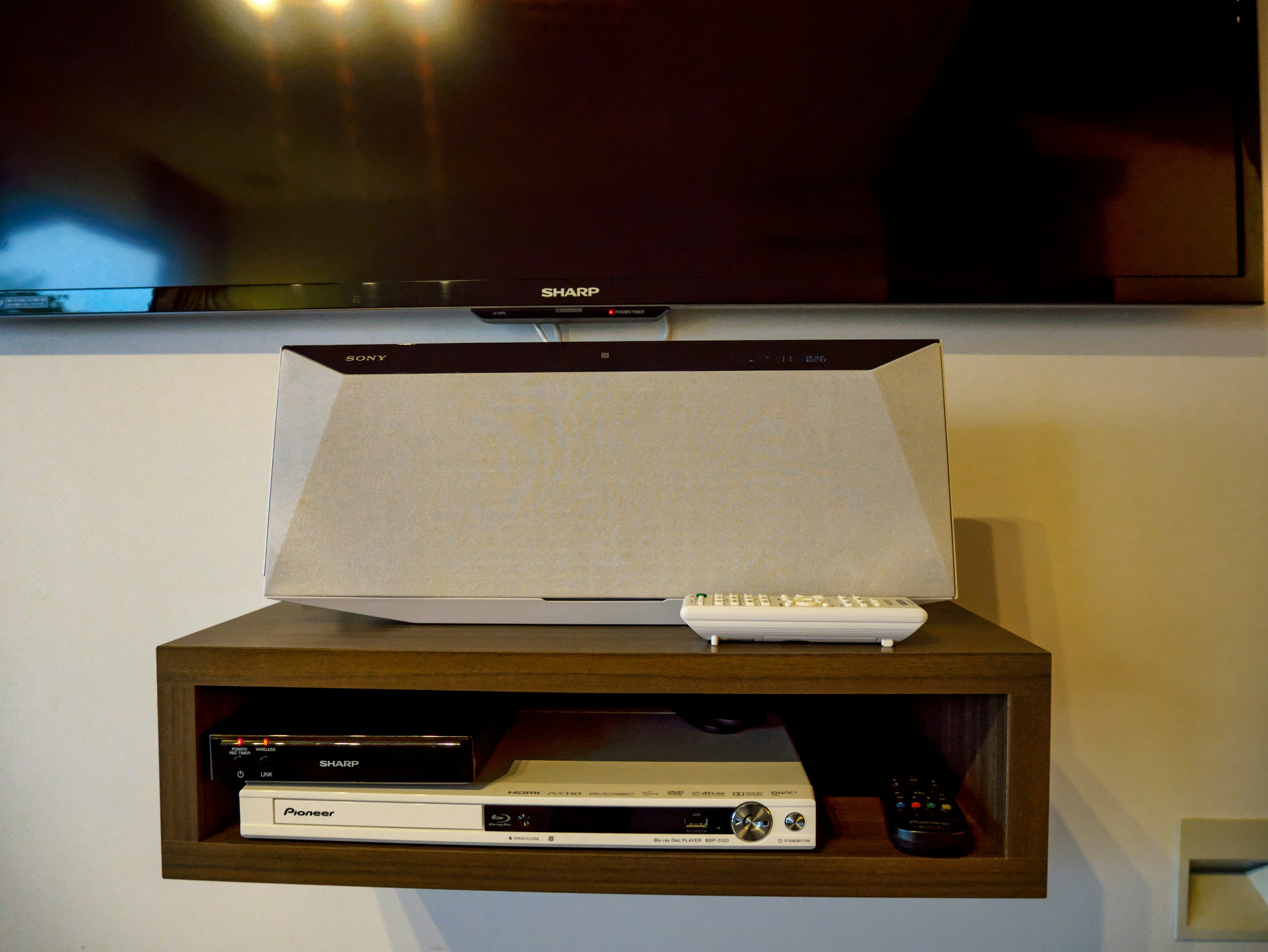 Modern audio system under a TV with a remote control