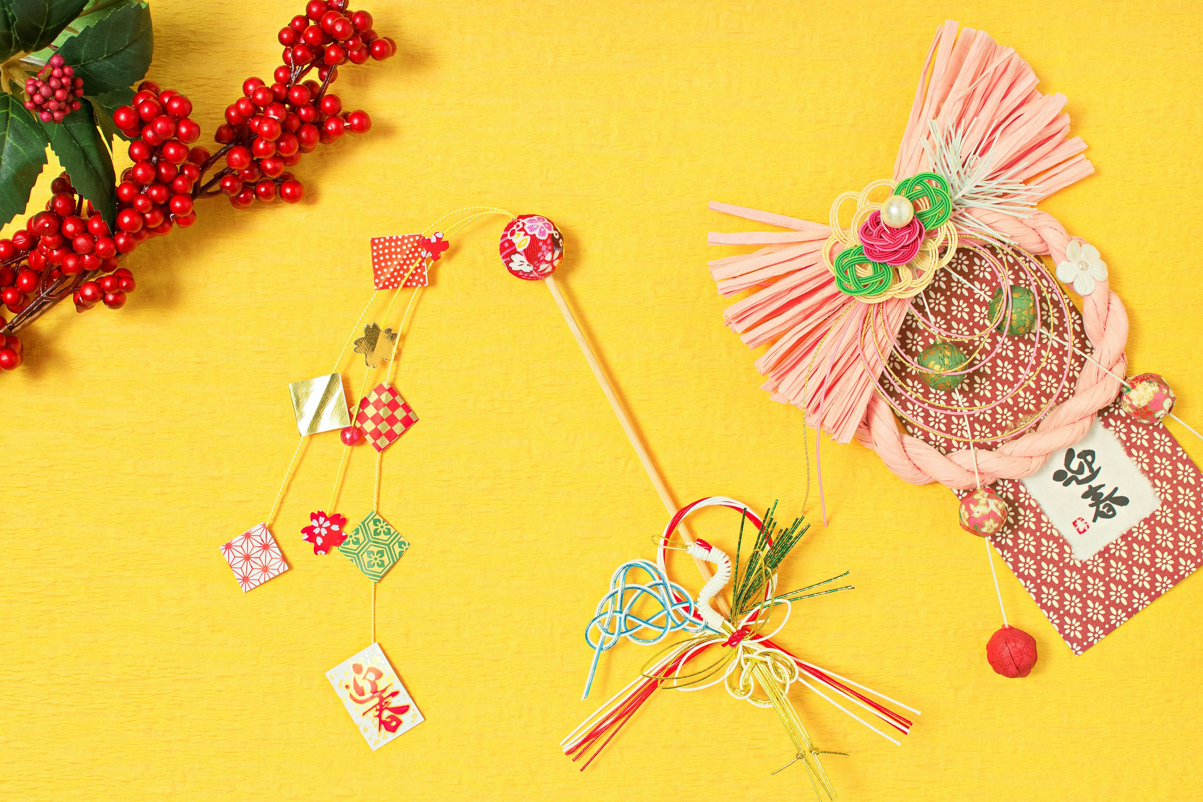 Image featuring decorative items on a yellow background with a branch of red berries