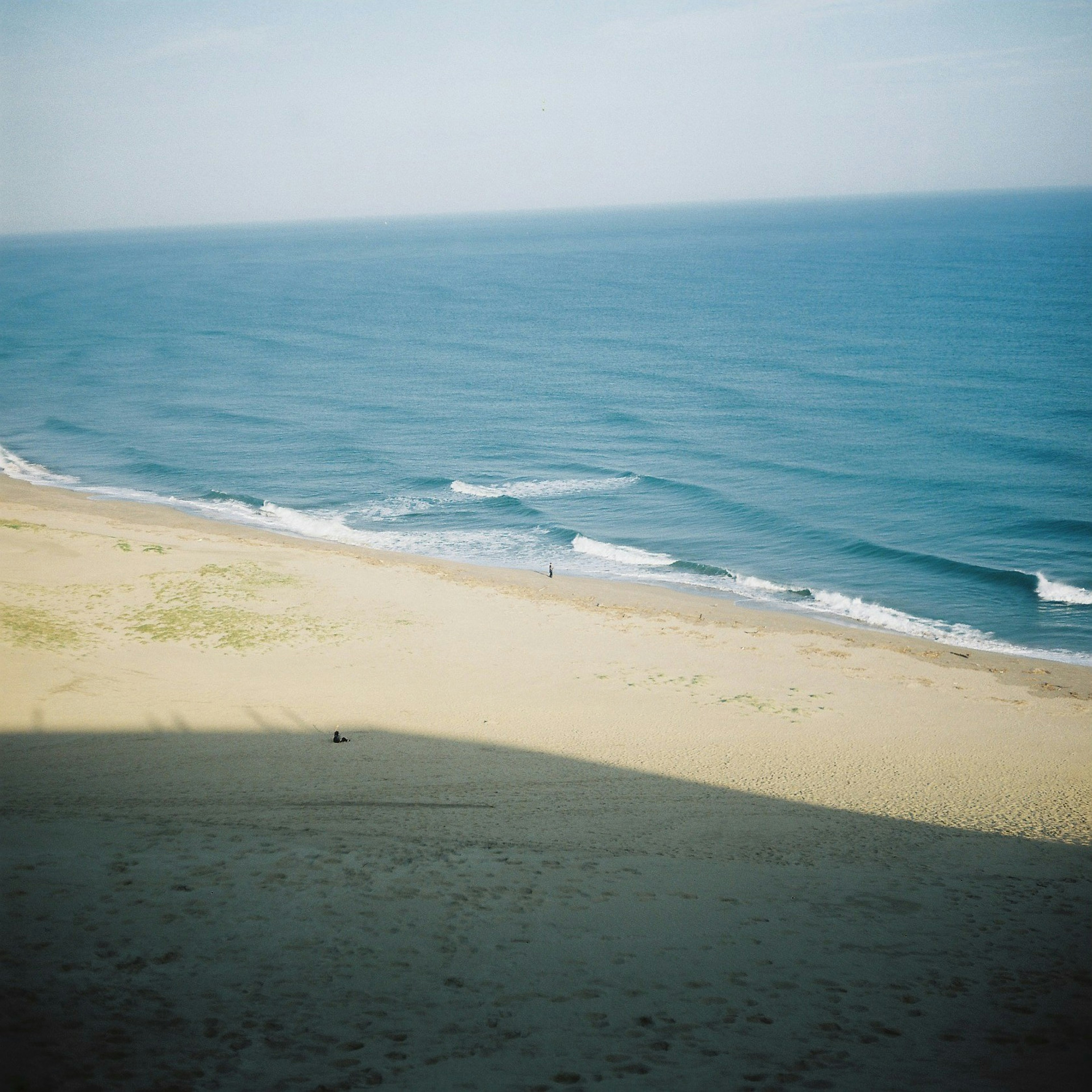 ทิวทัศน์ของมหาสมุทรสีน้ำเงินและชายหาดทราย