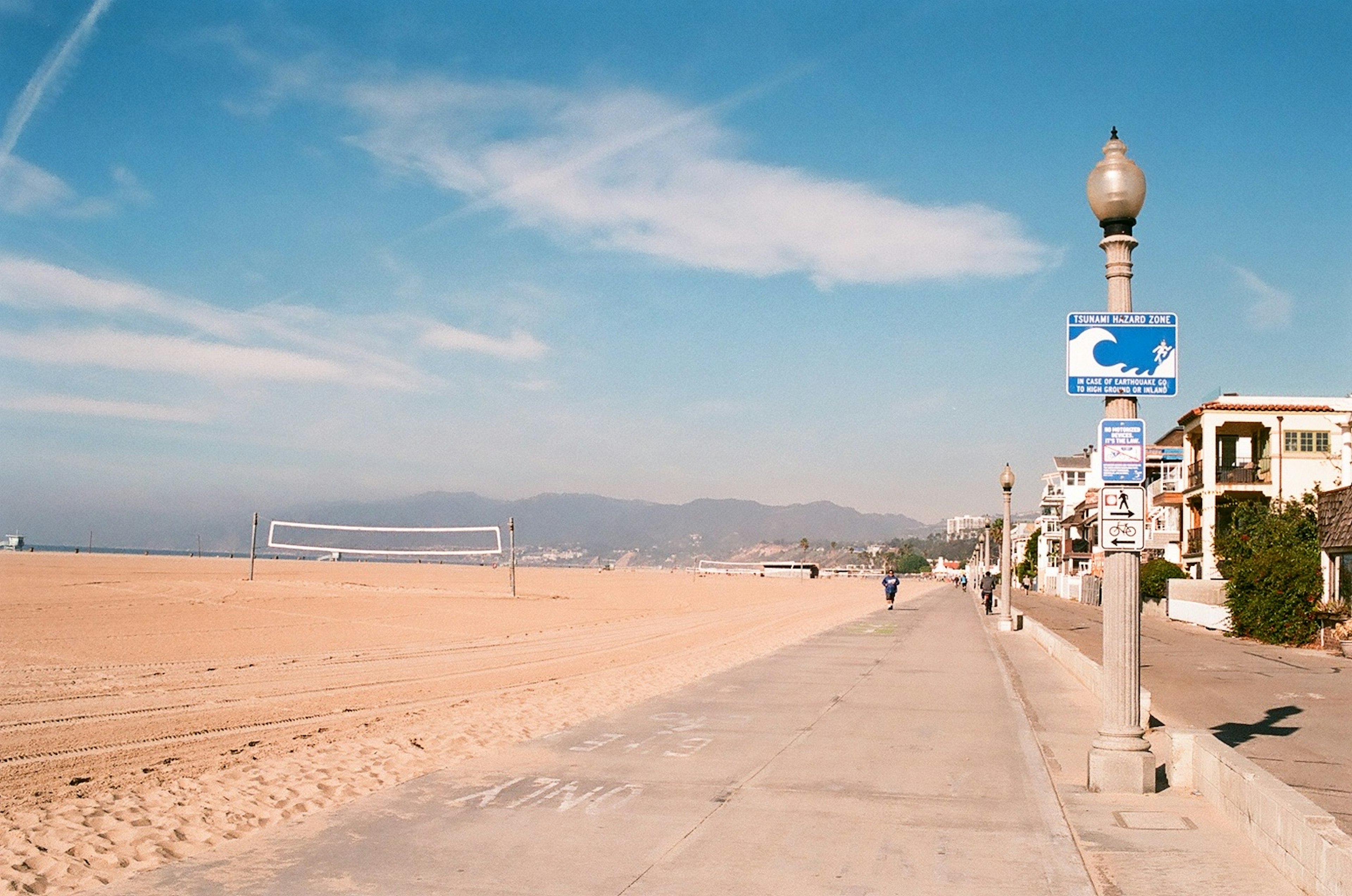 Sidewalk view with beach and ocean in the background