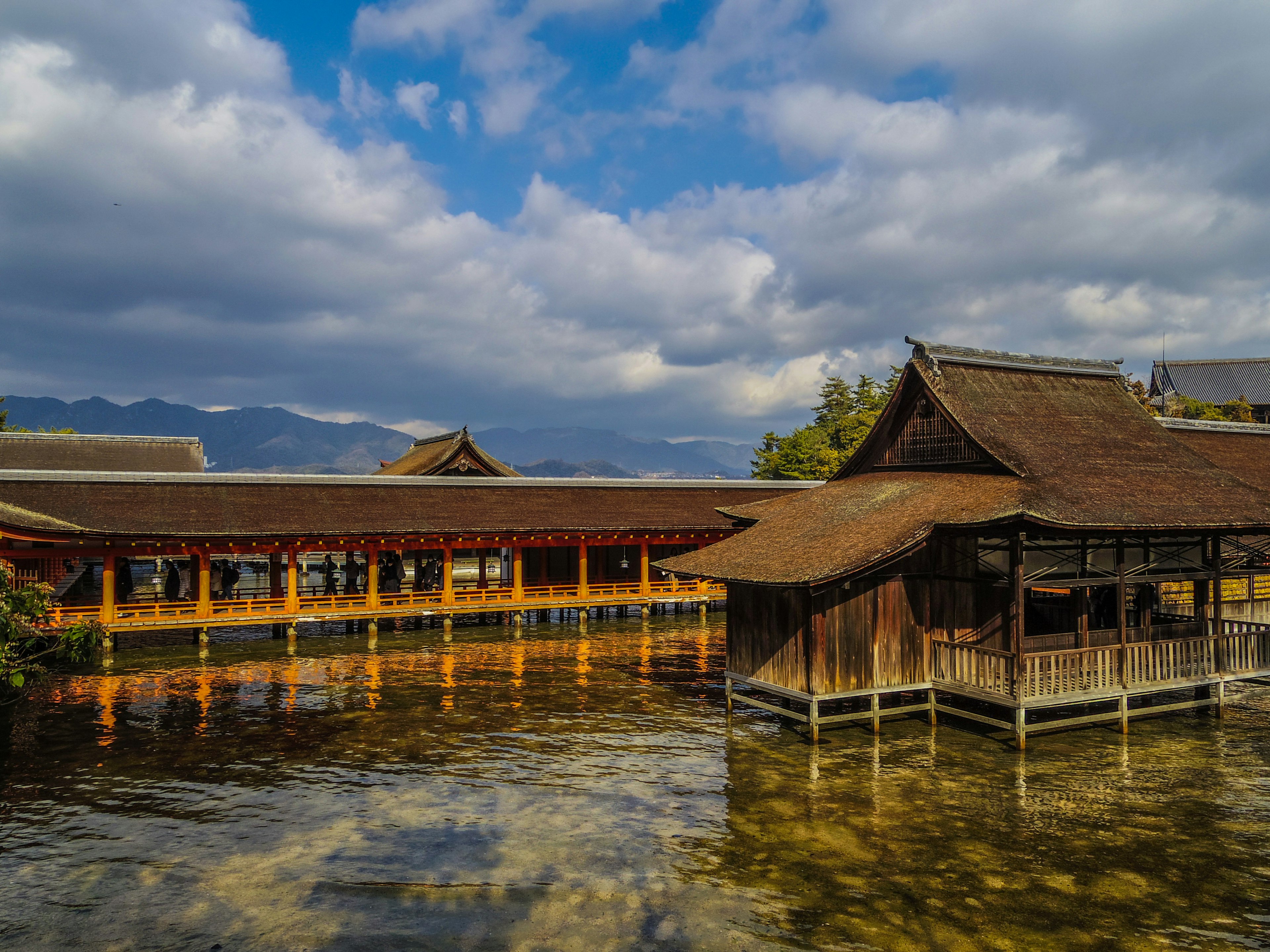 Traditional wooden buildings by the water under a blue sky