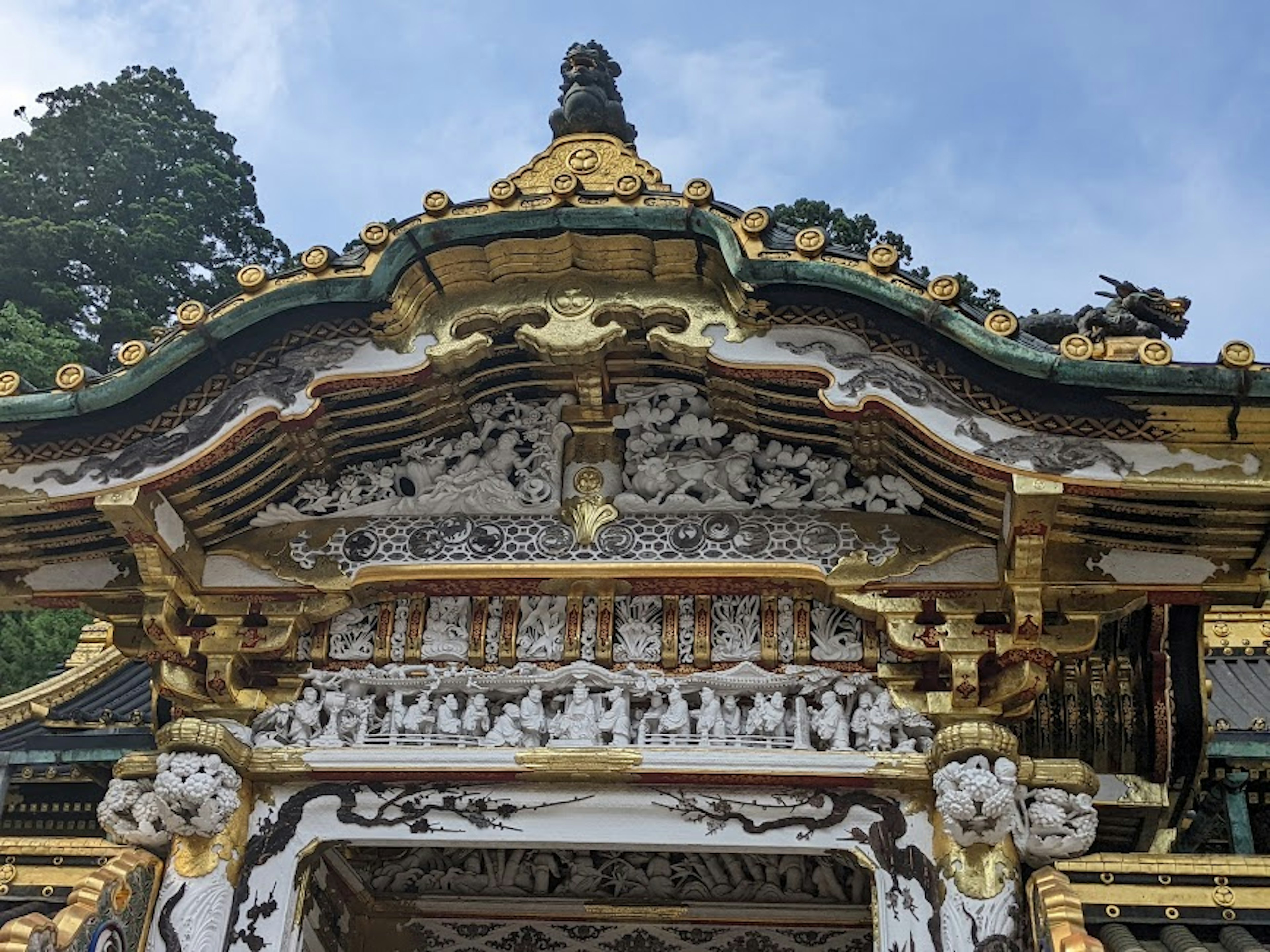 Ornately decorated section of a shrine roof with intricate carvings