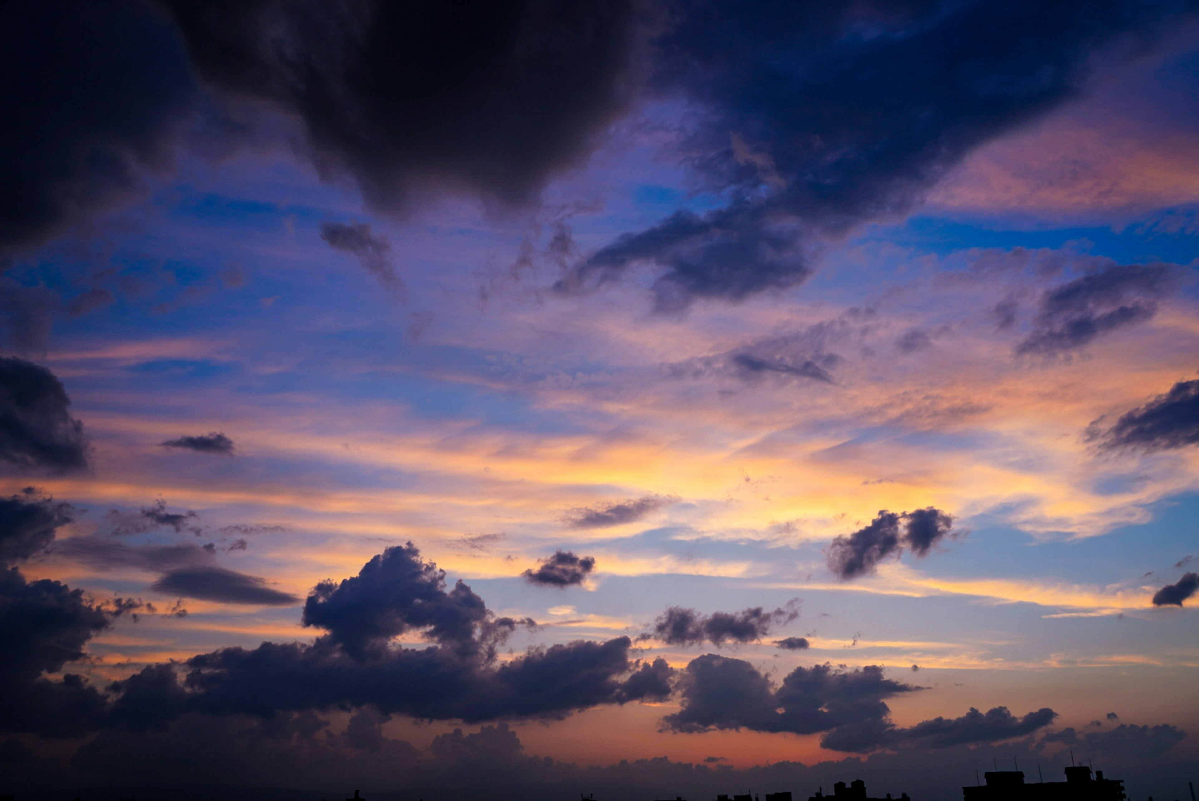 Beautiful sunset sky with blue and orange clouds