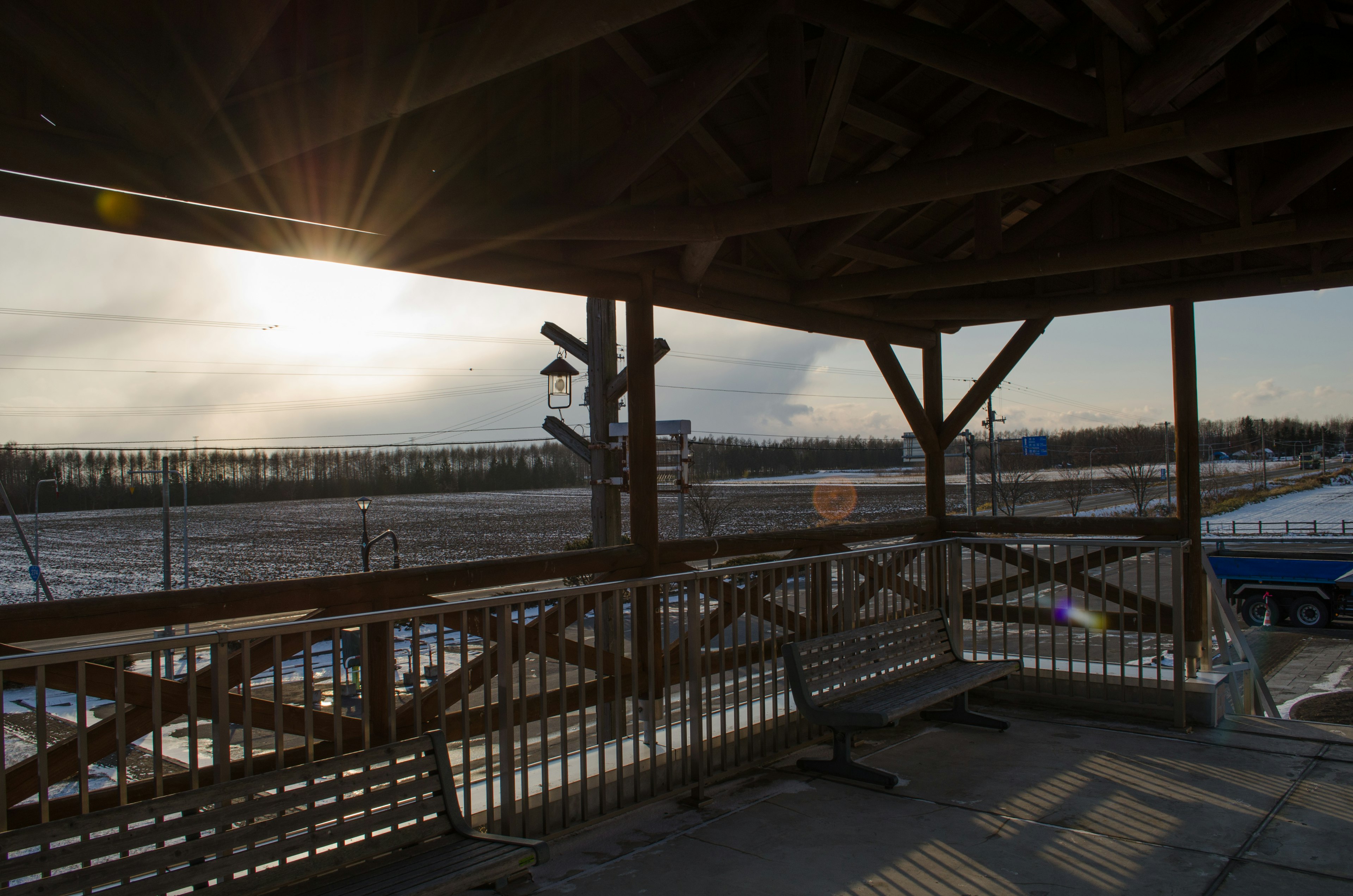 Winter landscape and sunset viewed from a wooden deck