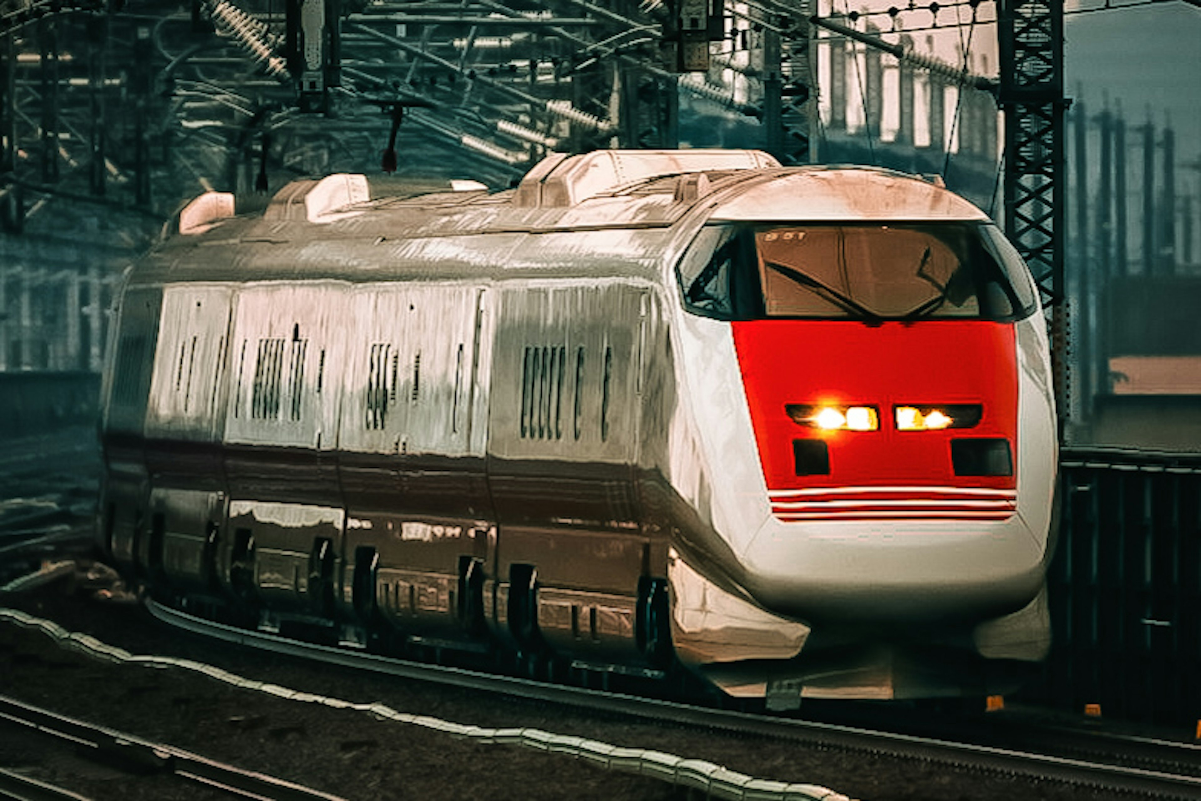 Shinkansen train with red front approaching the station