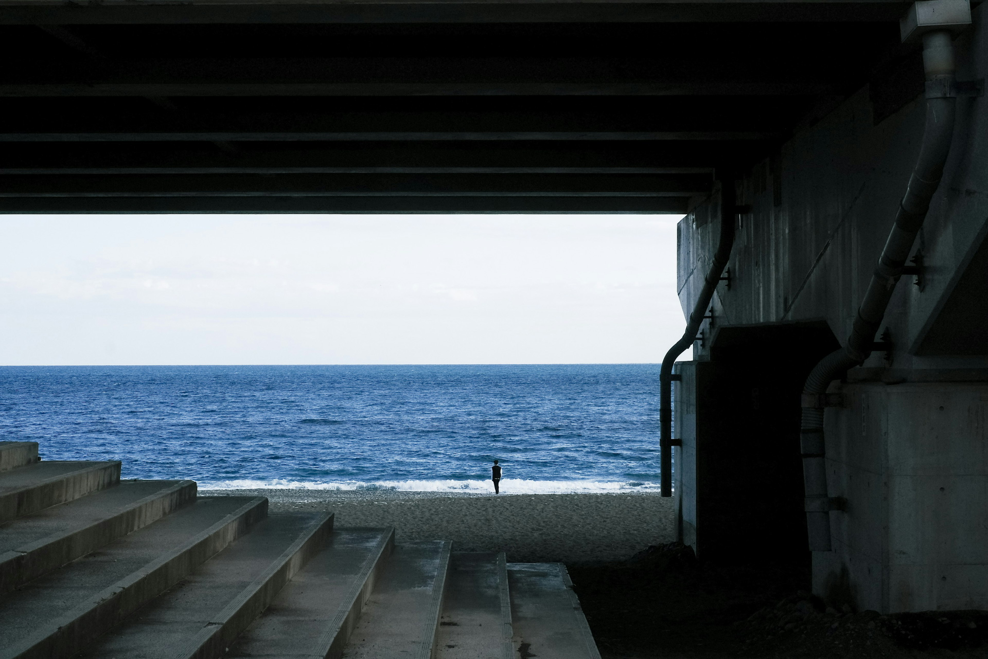 View of stairs and concrete structure with the ocean in the background