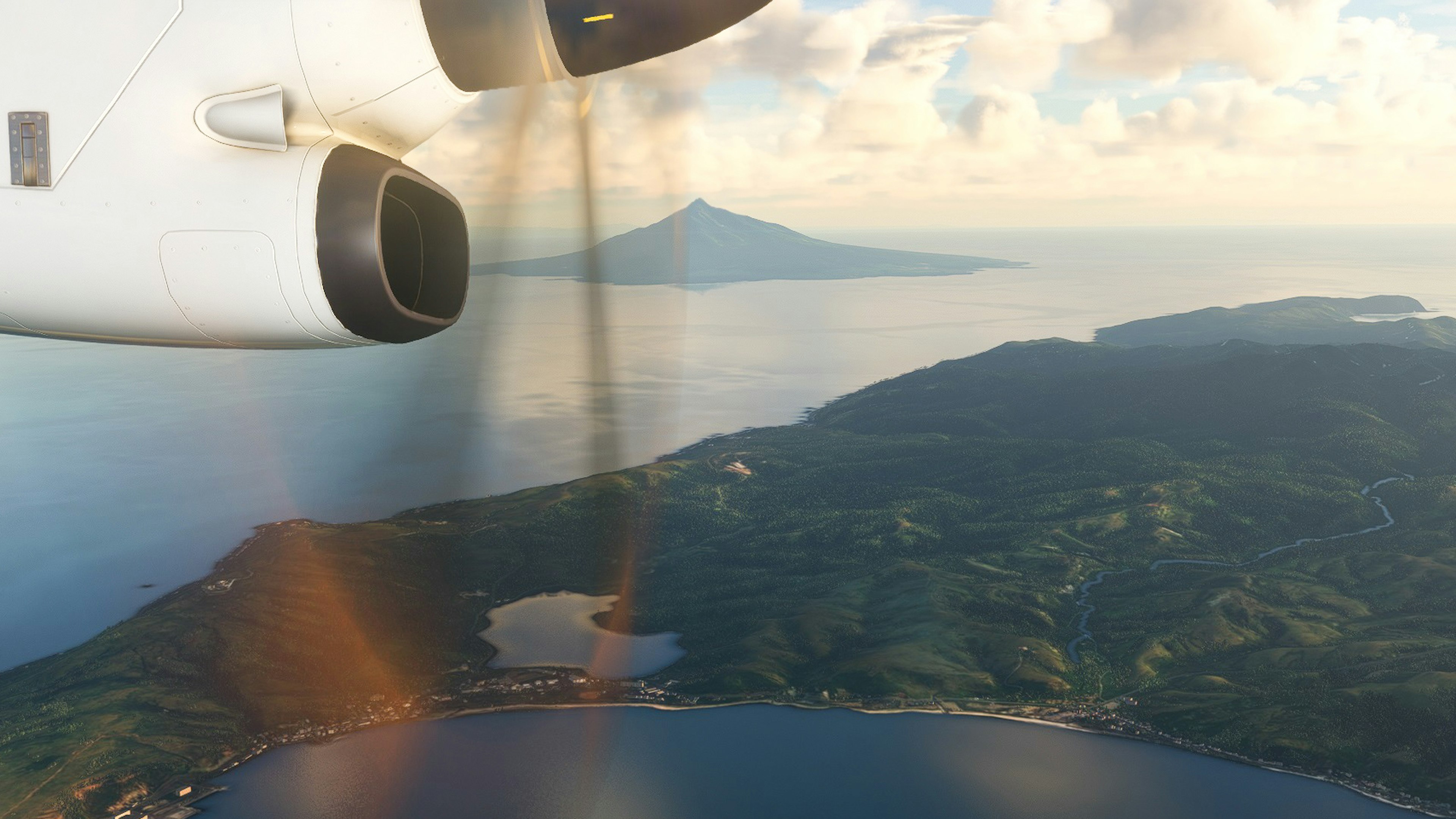 Aerial view from an airplane showing a propeller and a coastal landscape