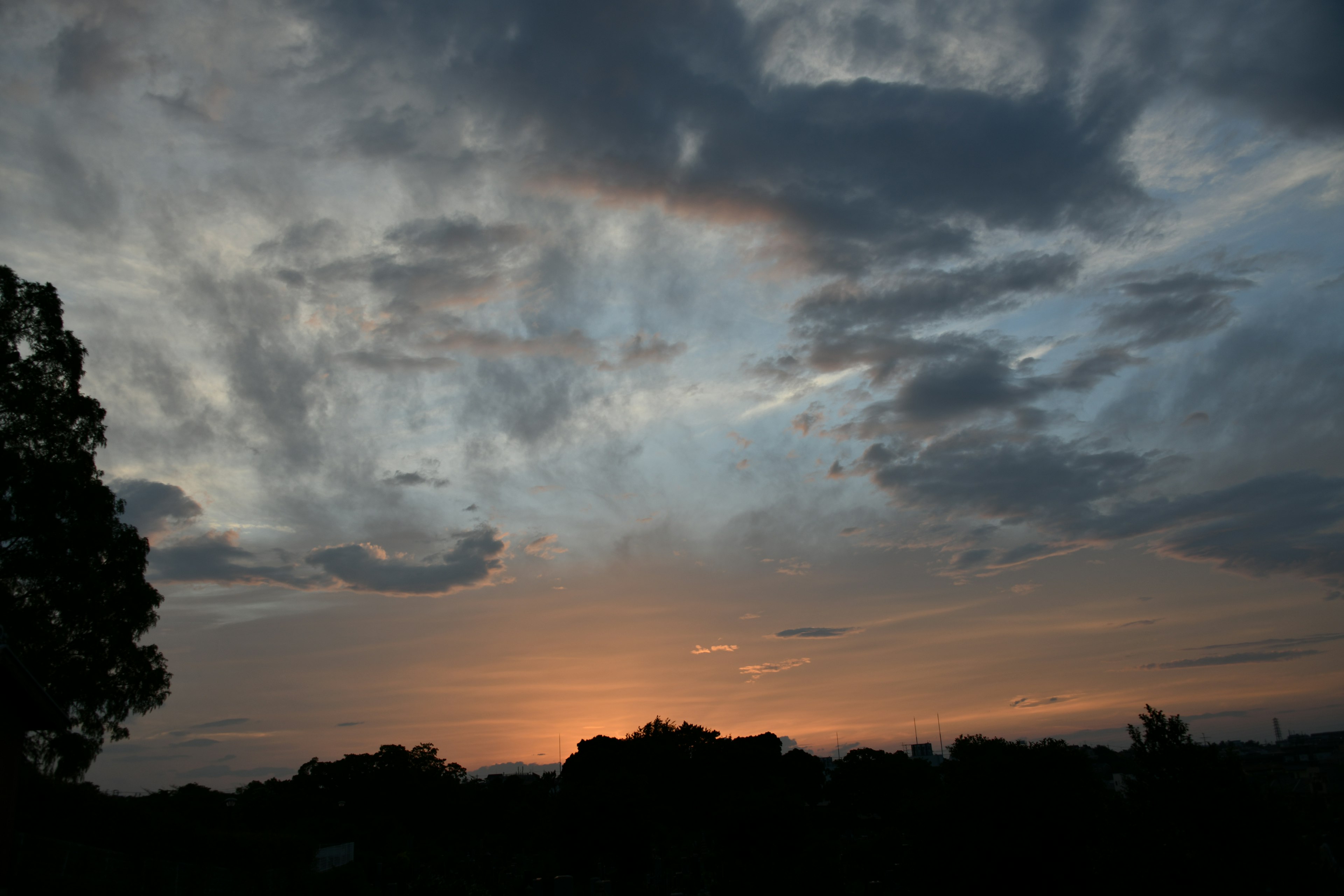 A beautiful sunset landscape with dark silhouettes against the sky