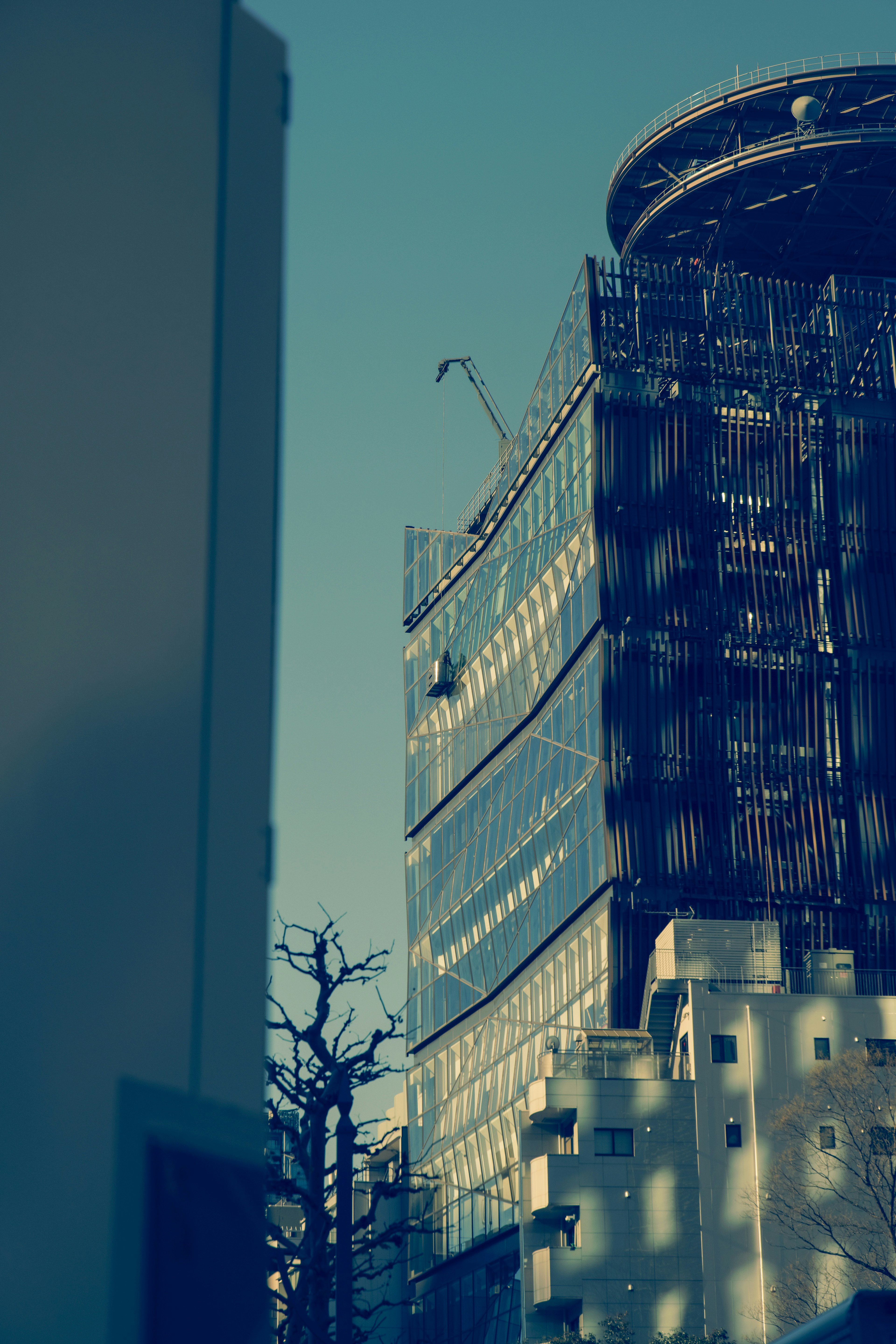 Construction site featuring a high-rise building against a blue sky