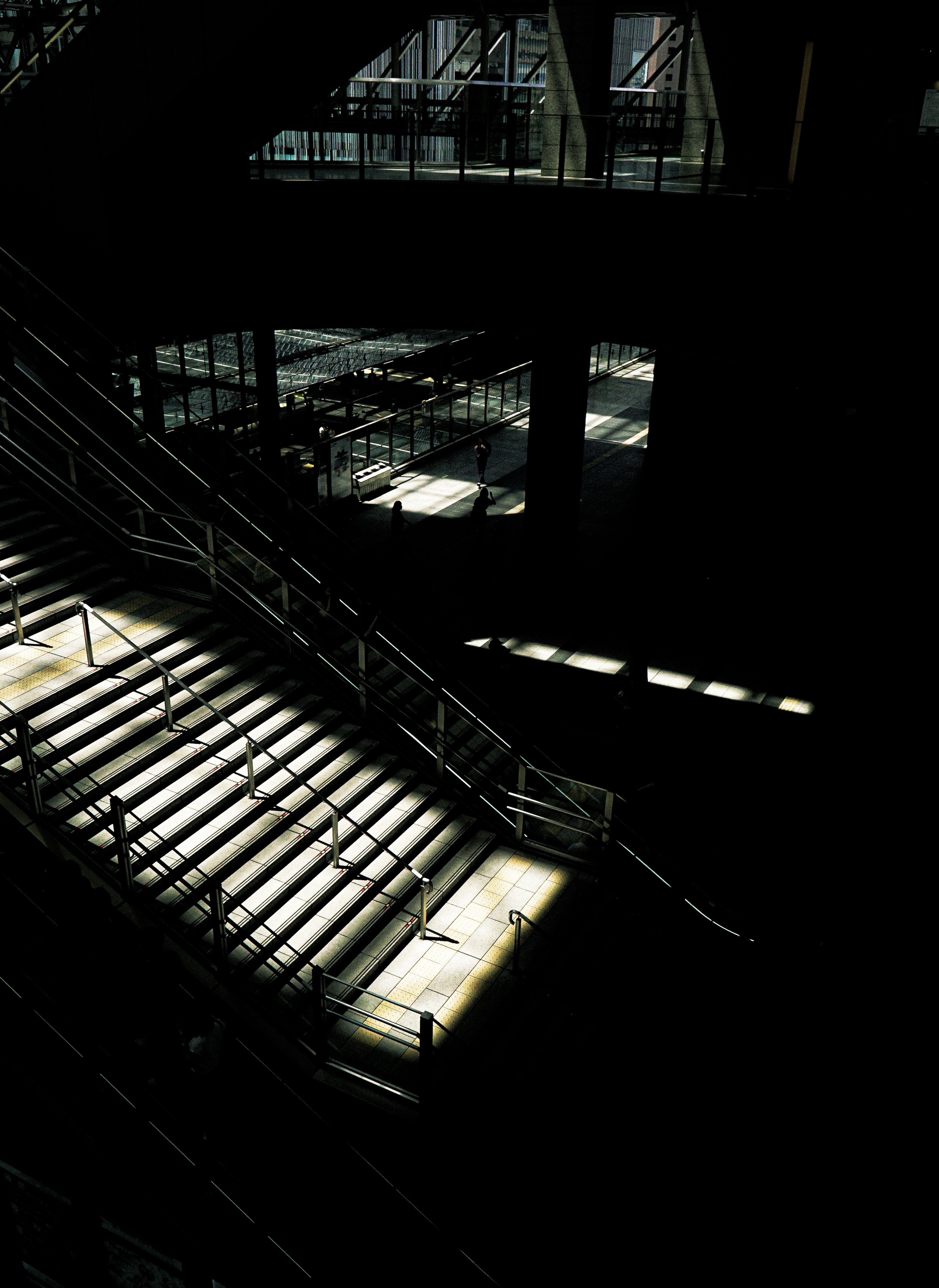 Contrasting shadows and light on a staircase in a dark space