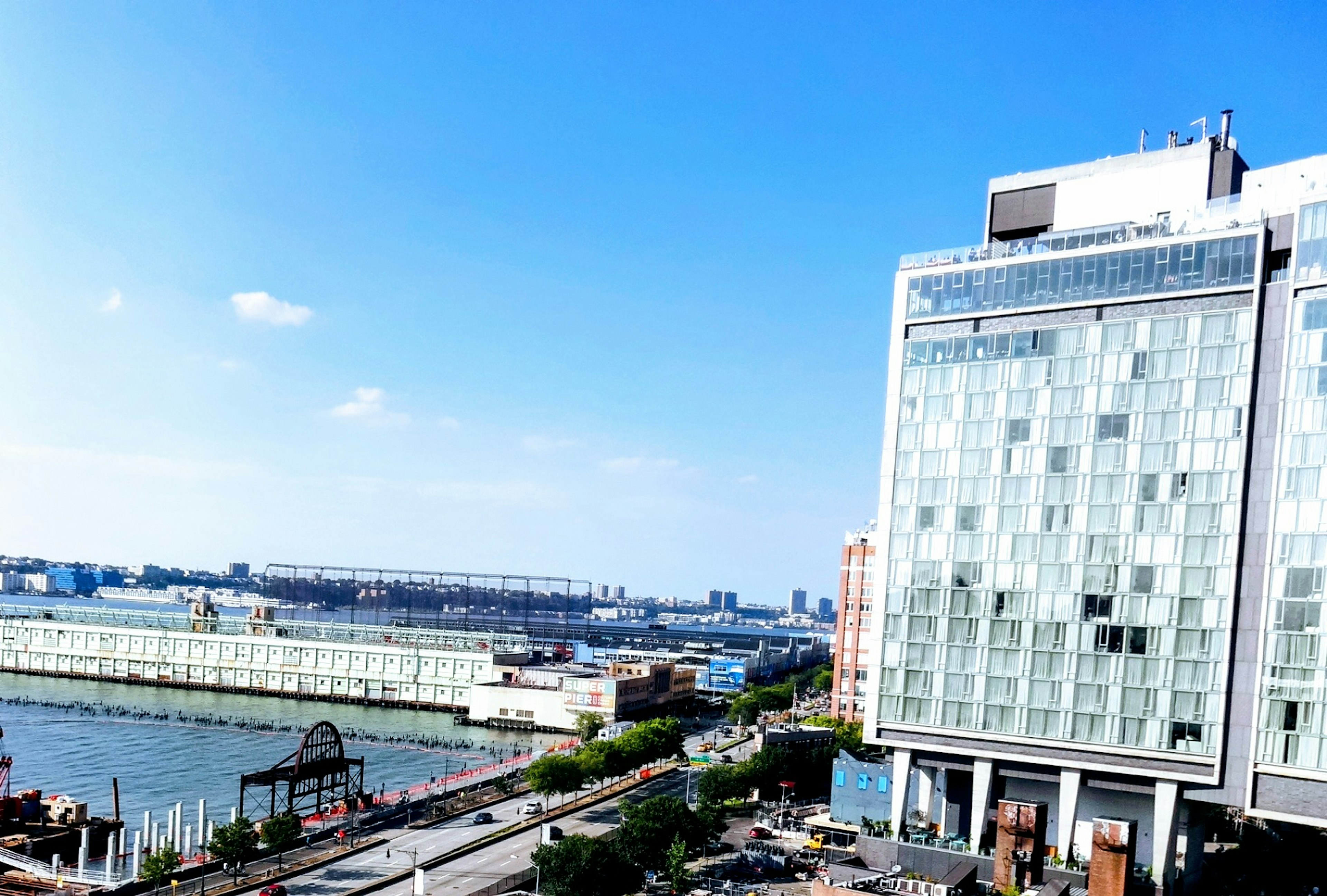 Modern building beside a river under a clear blue sky