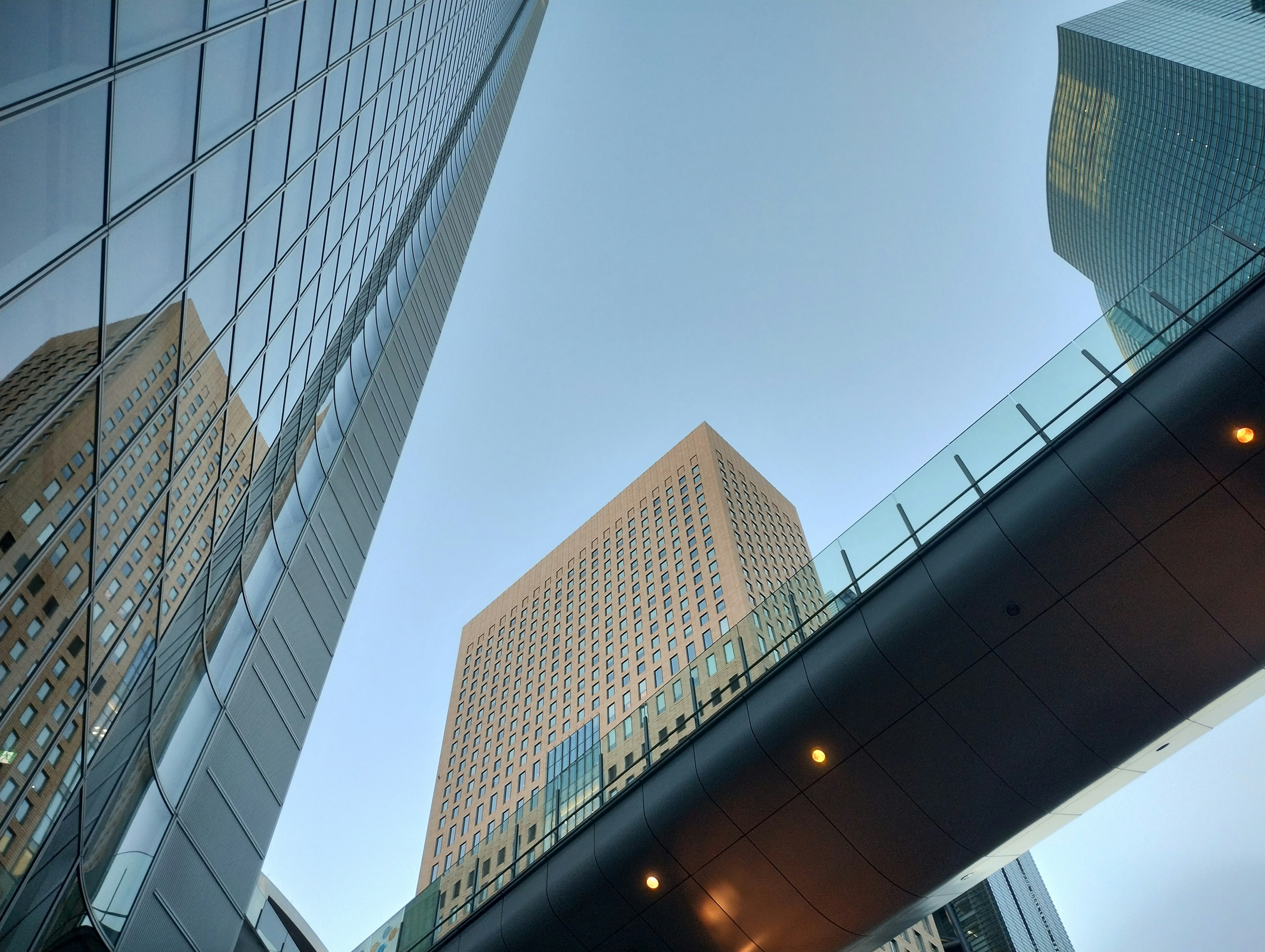 Urban landscape featuring skyscrapers and a glass bridge