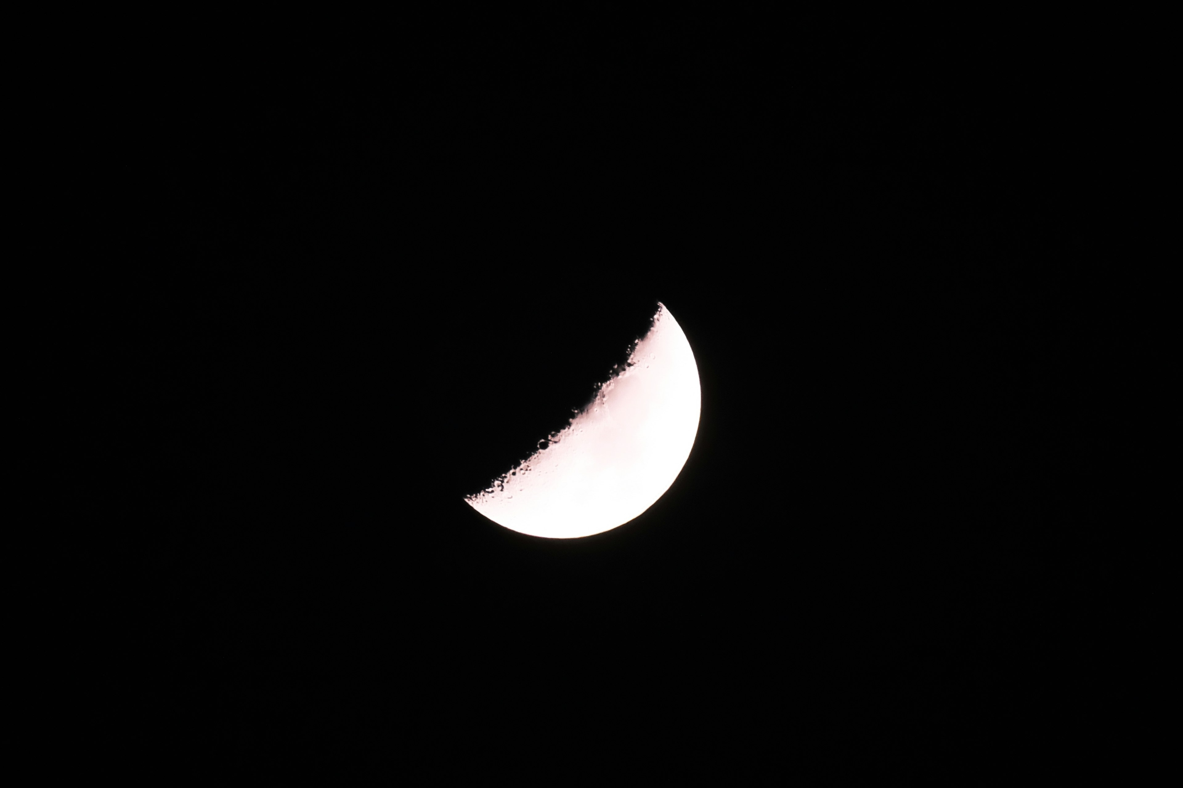 Thin crescent moon in the night sky