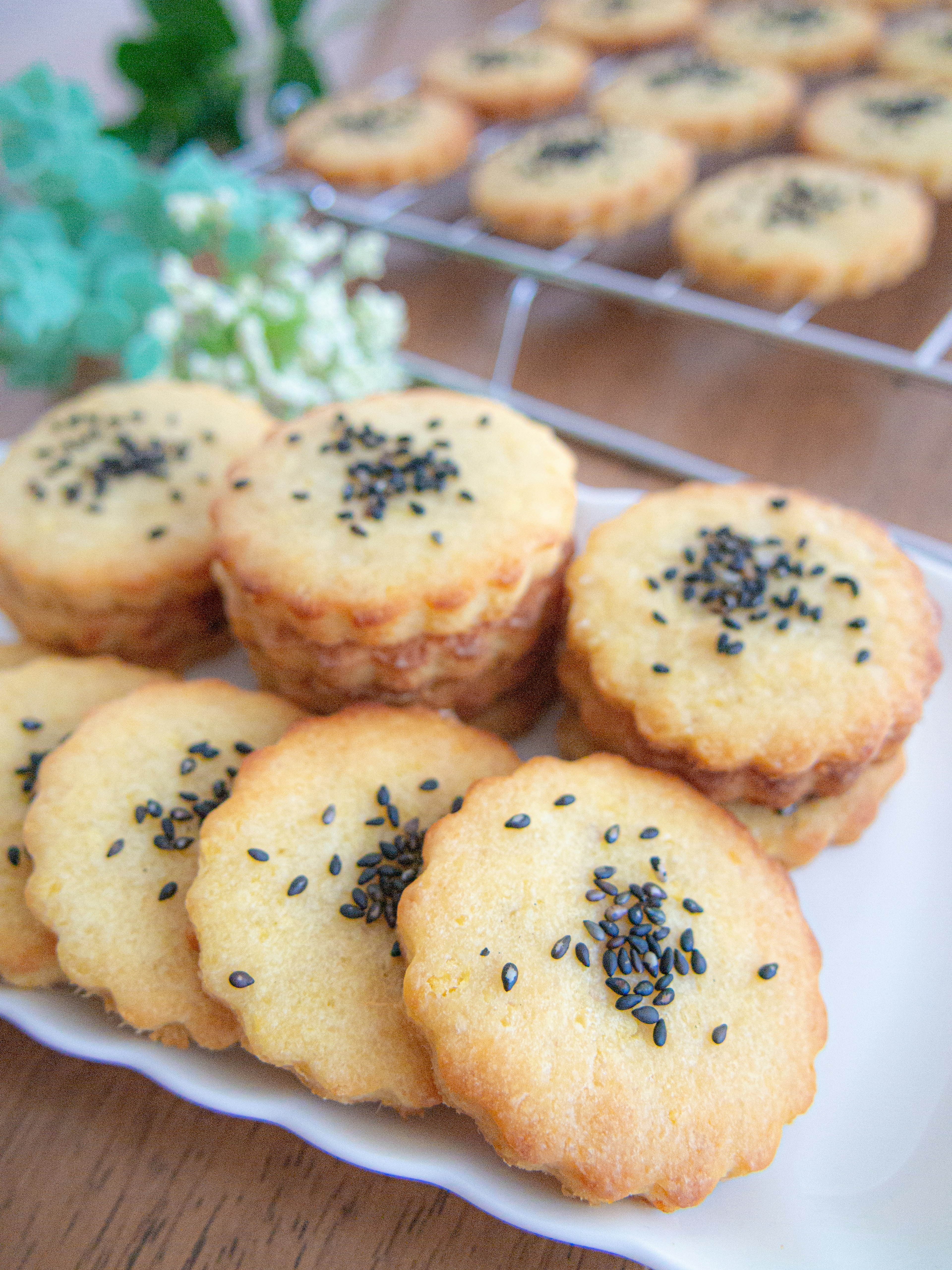 A platter of baked goods topped with black sesame seeds