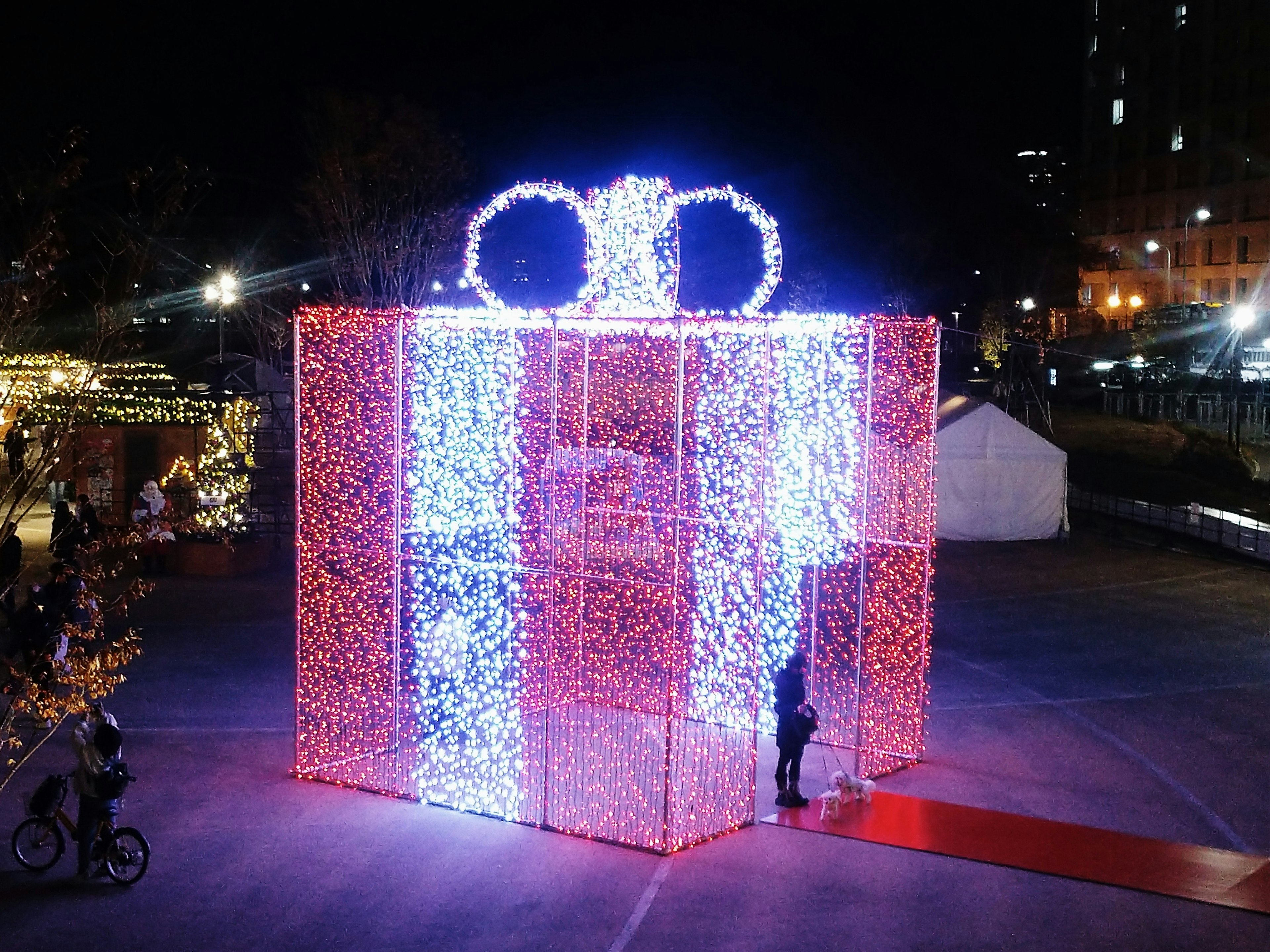 Large illuminated gift box decoration at night