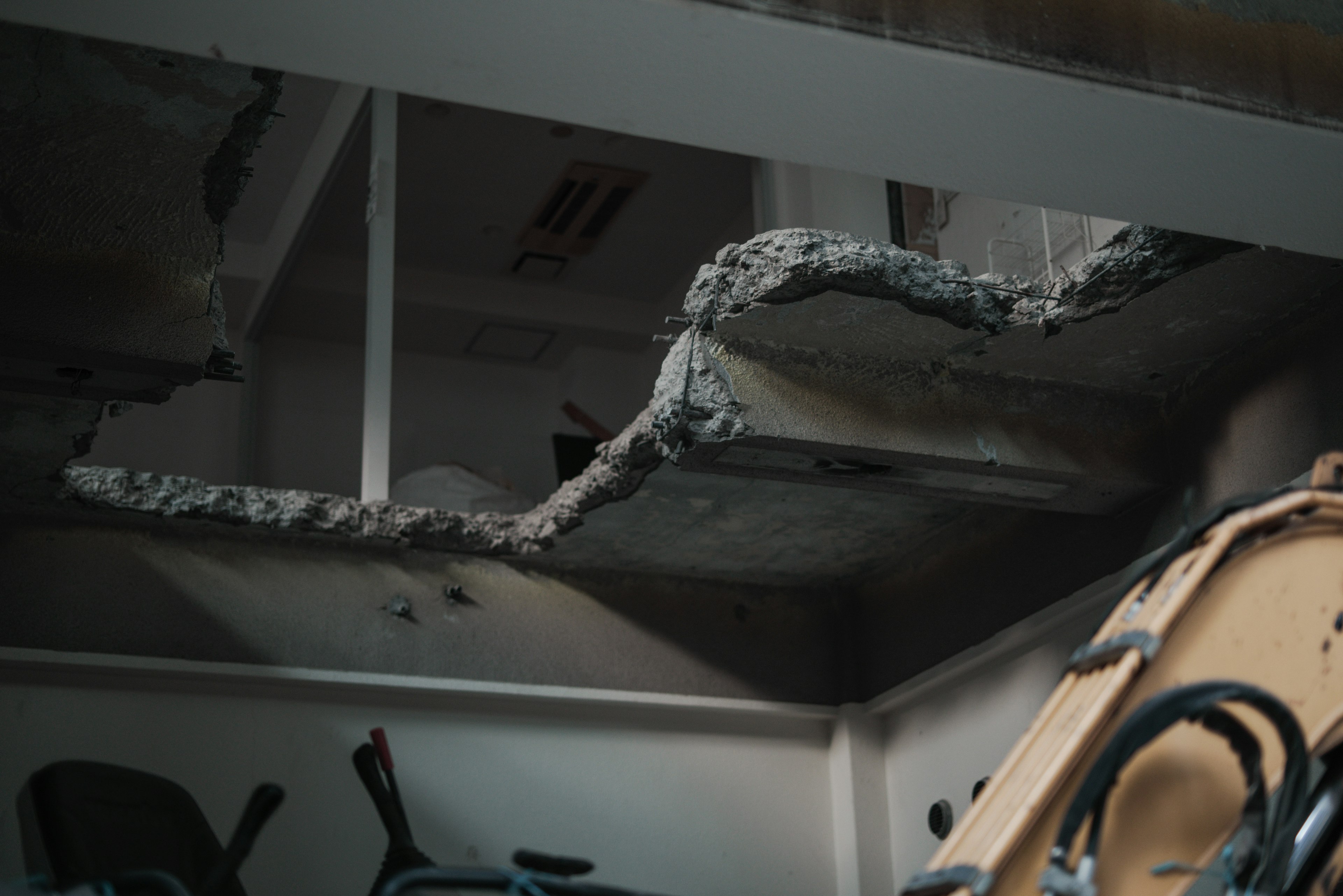 Interior view showing a damaged ceiling and furniture