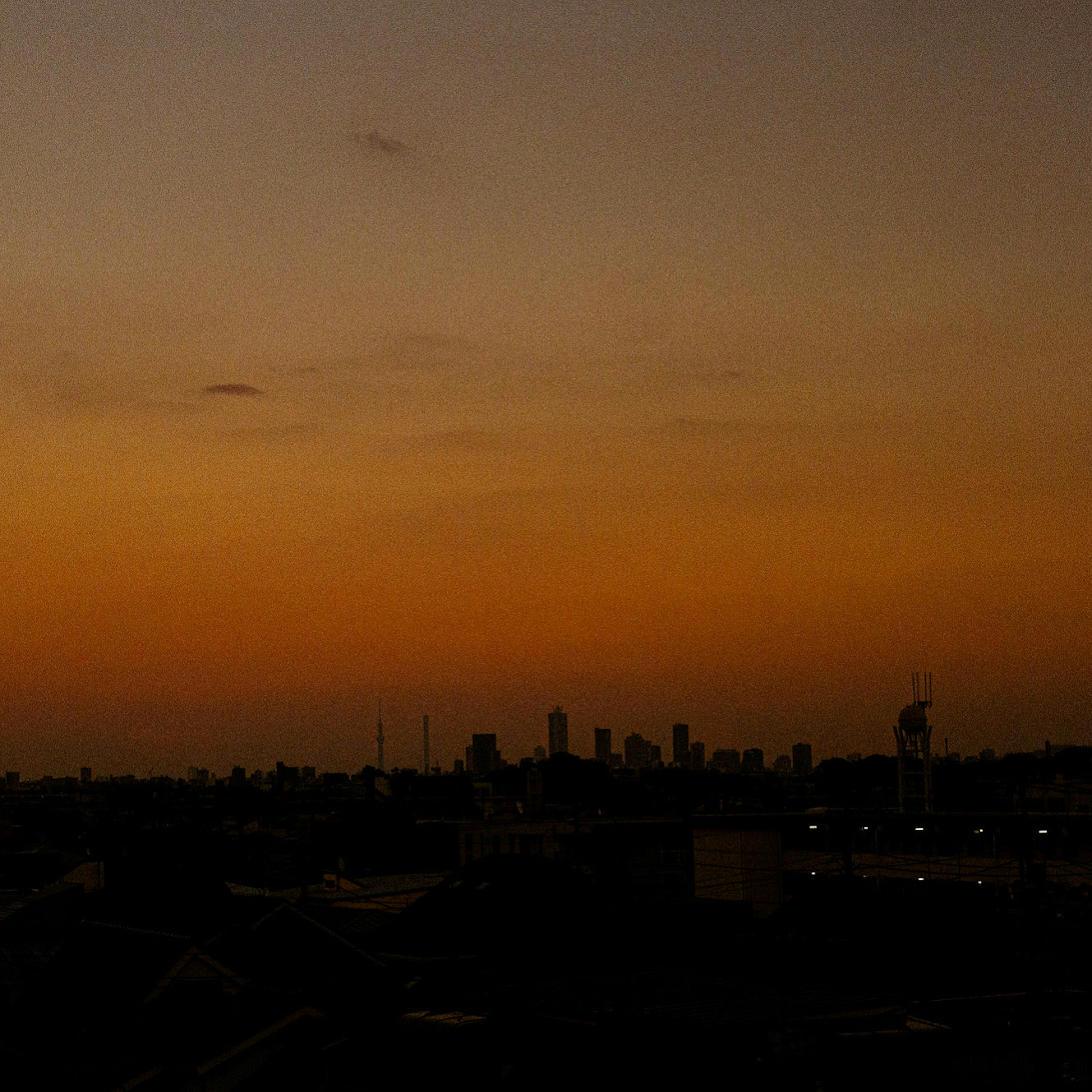 Sky at sunset with city skyline silhouette