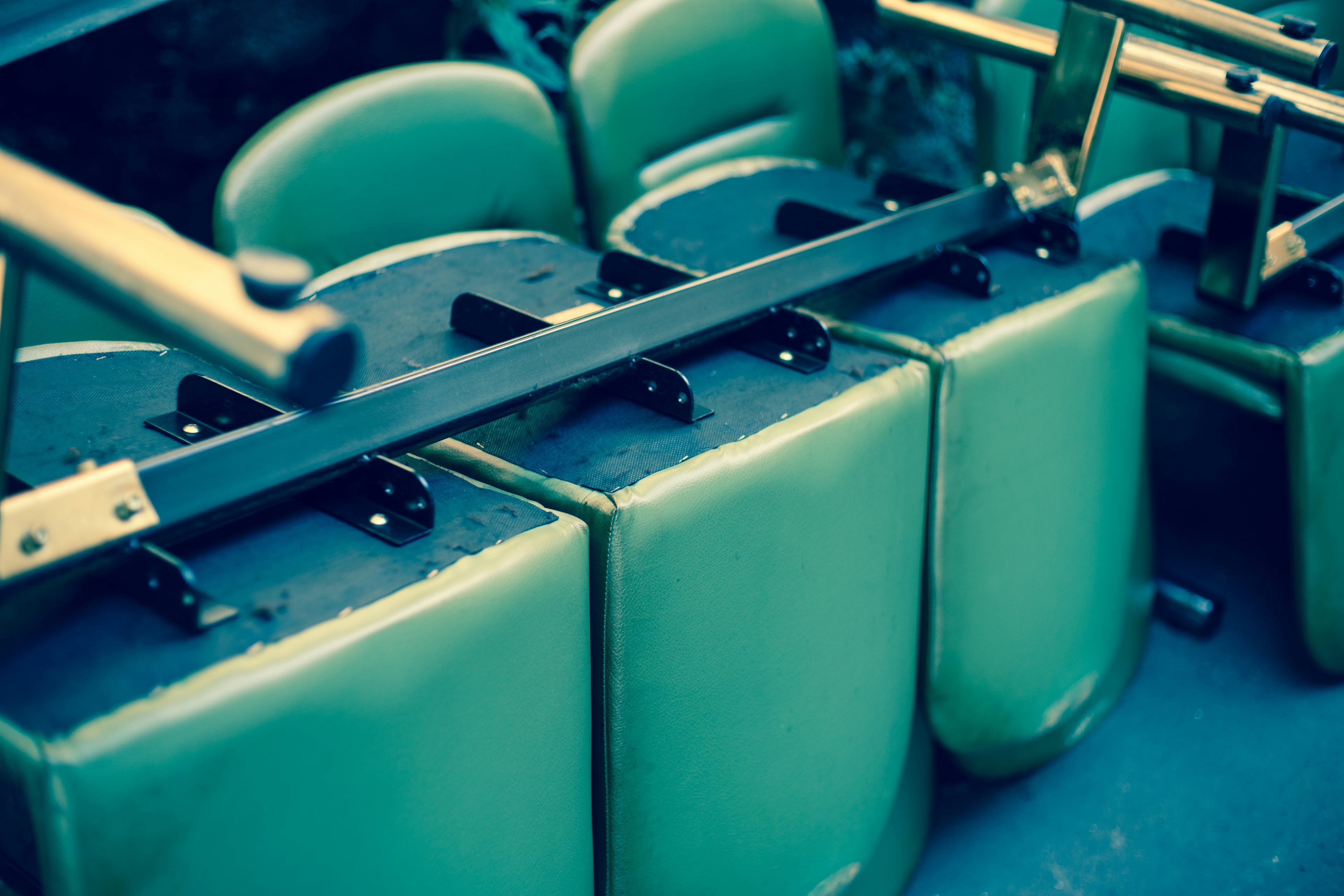 Image showing parts of green cushioned chairs with a metal frame