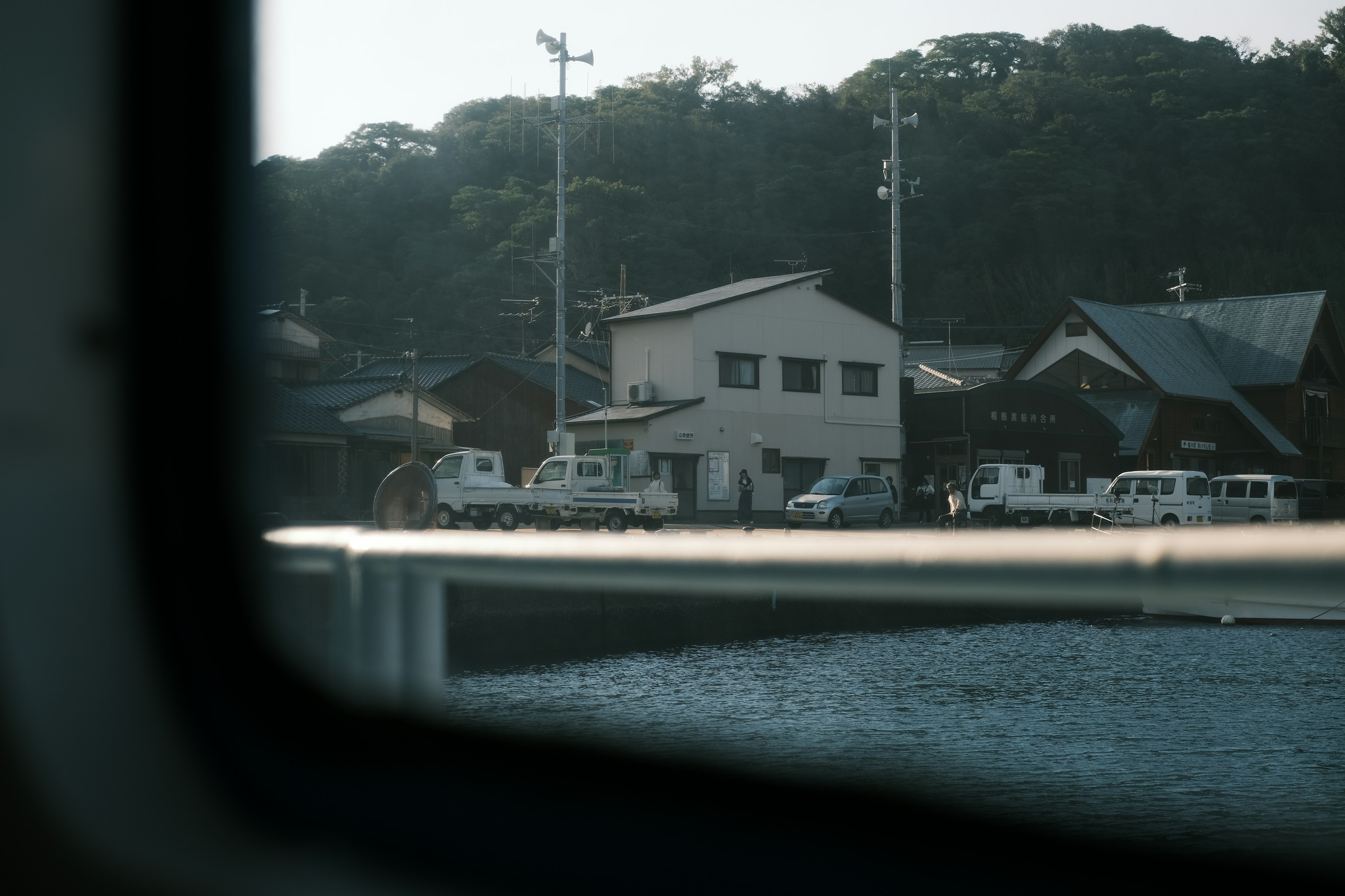 船の窓から見た静かな港町の風景