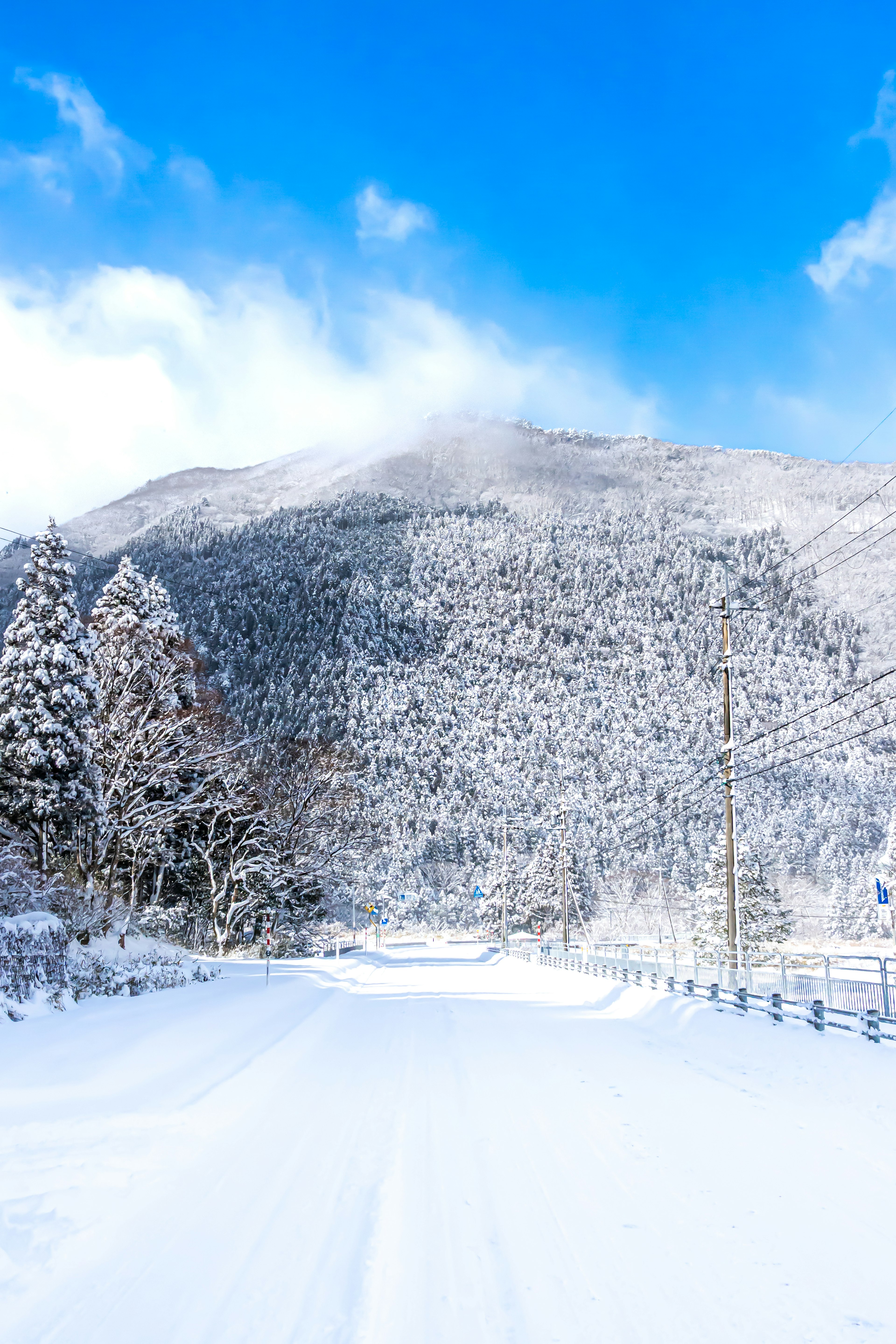 Snow-covered mountain landscape under a bright blue sky