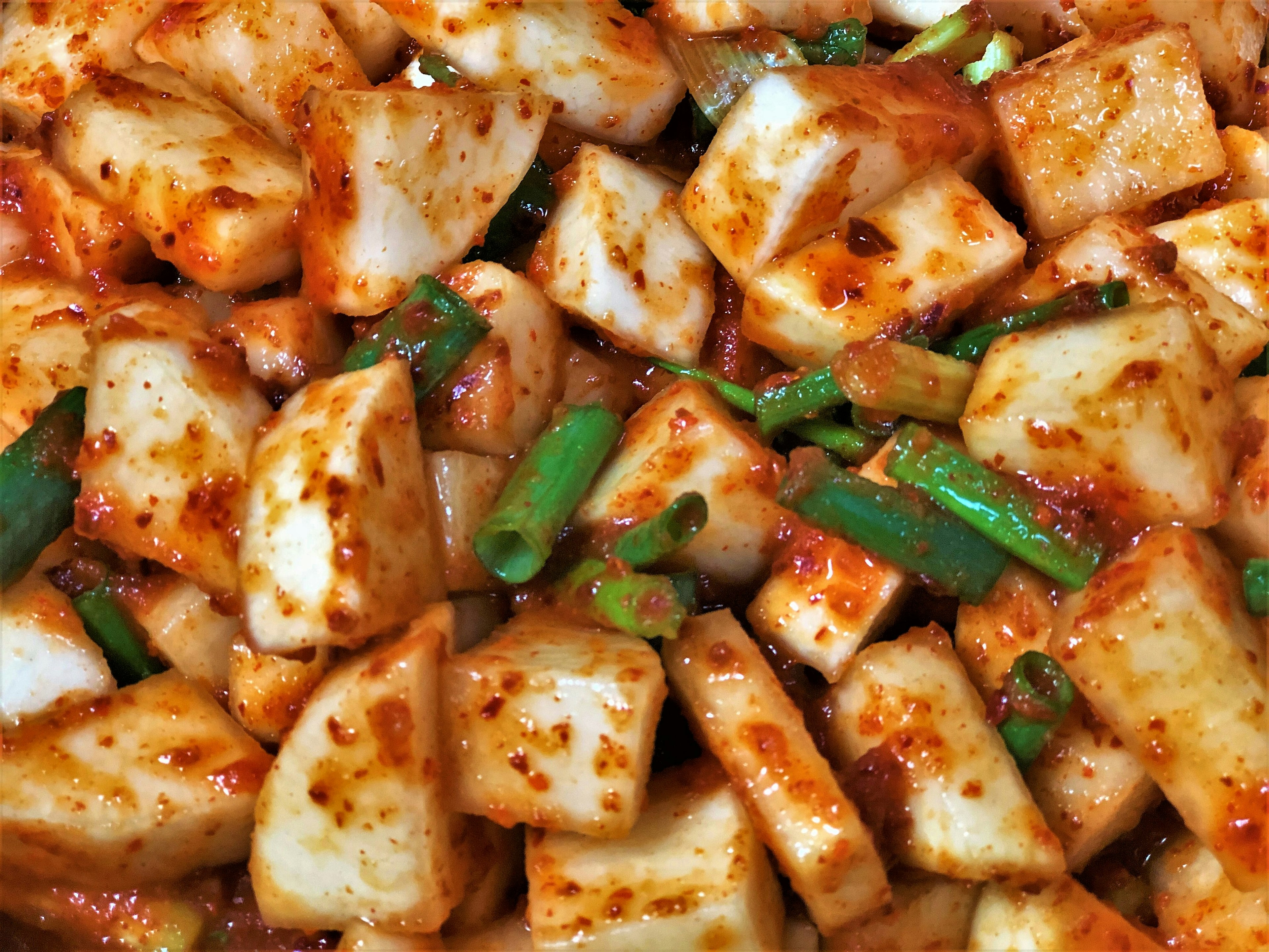 Diced radish mixed with red seasoning and green onions