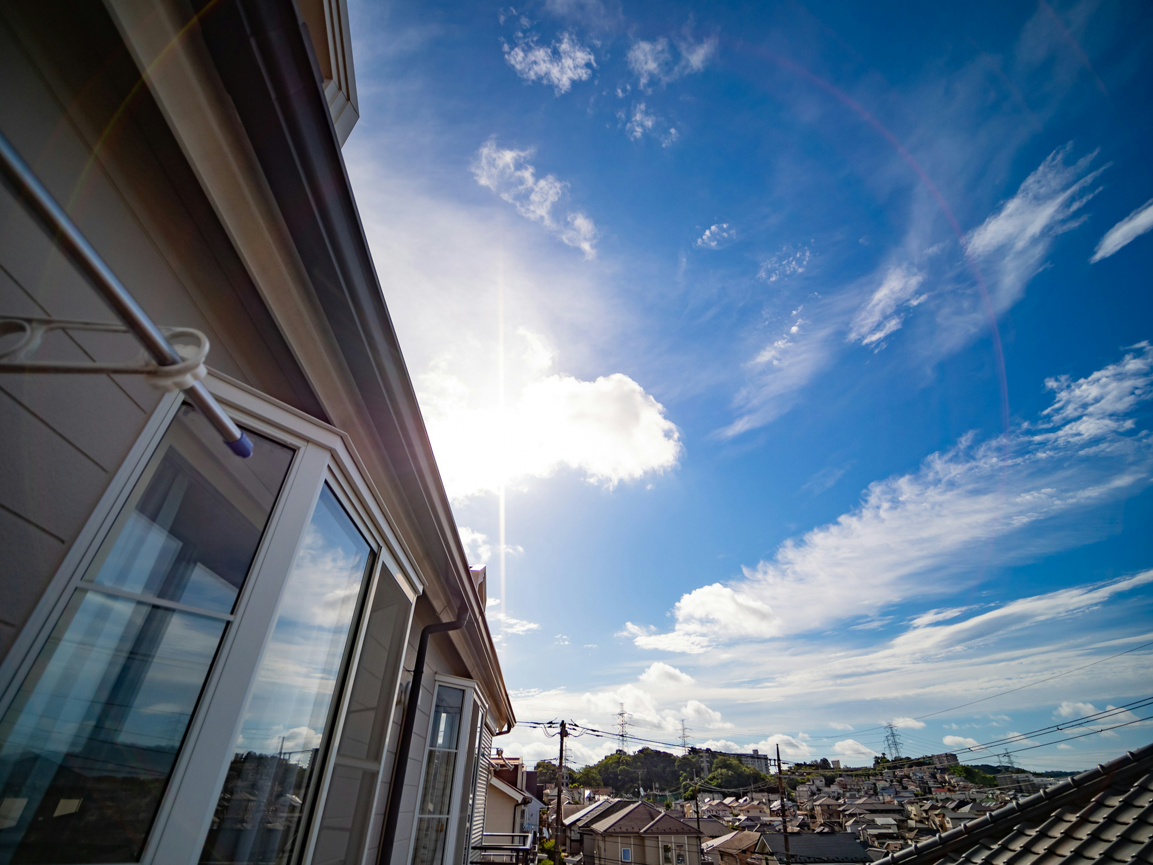 View from a rooftop with blue sky and scattered clouds