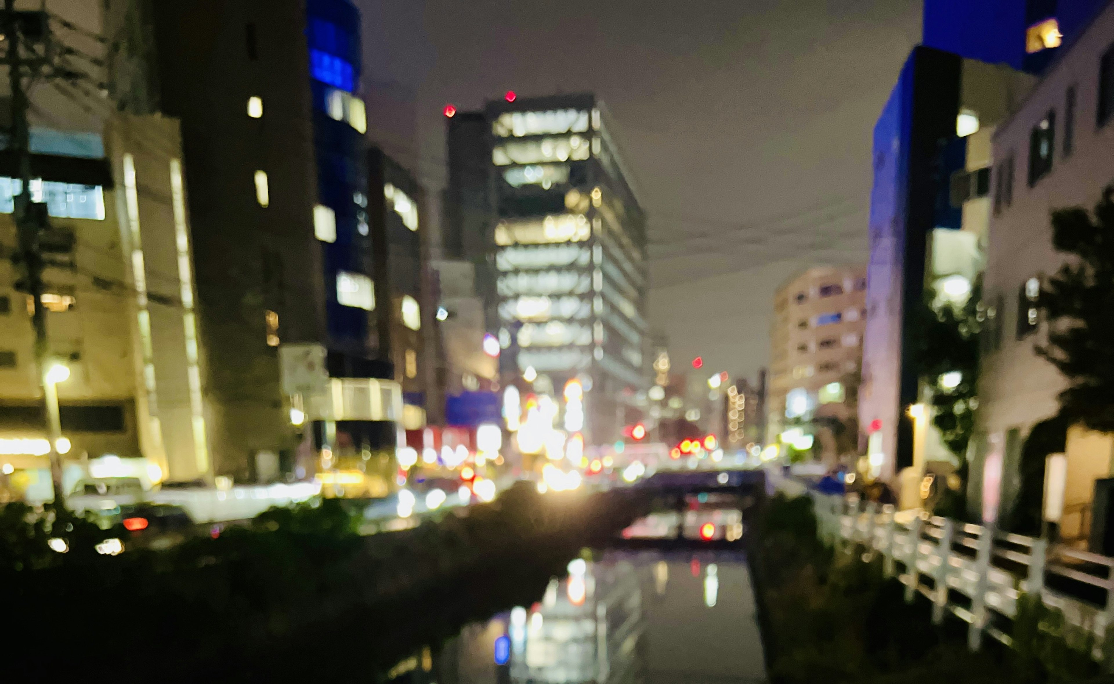 Night cityscape featuring bright buildings and a river