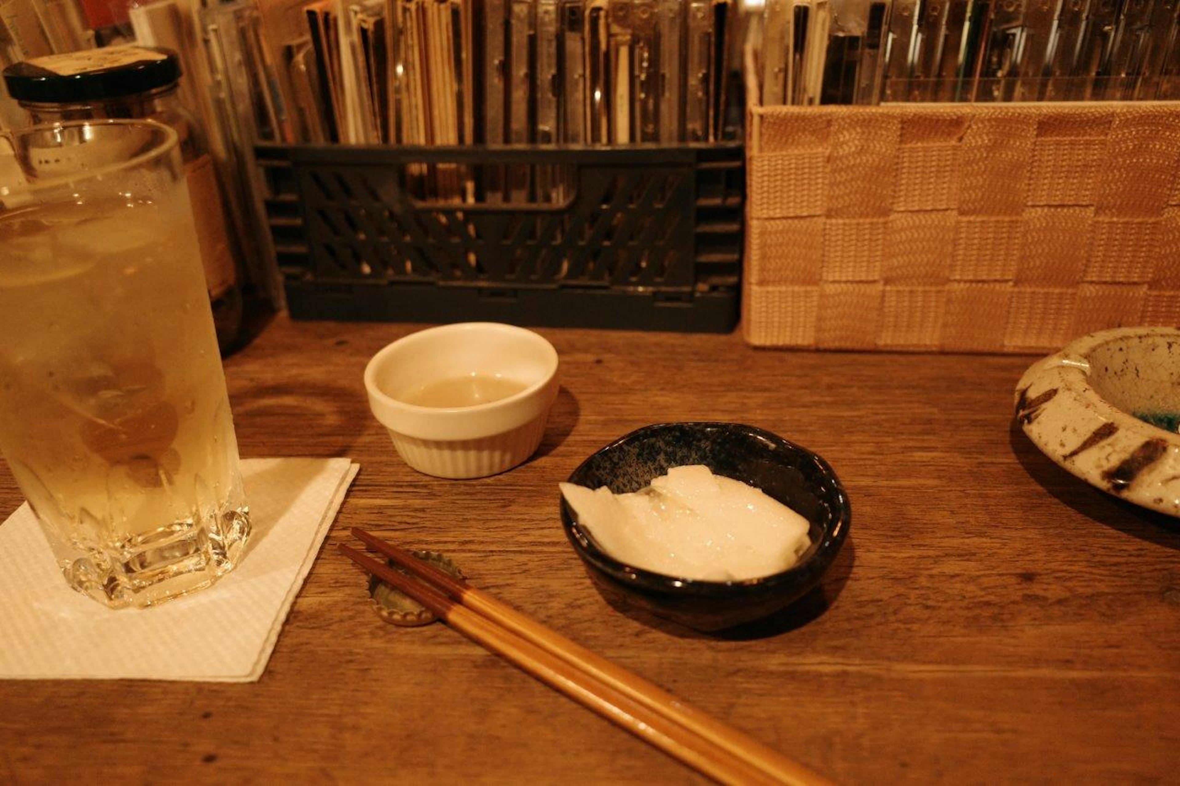 Table setting featuring a drink, small dishes, and chopsticks