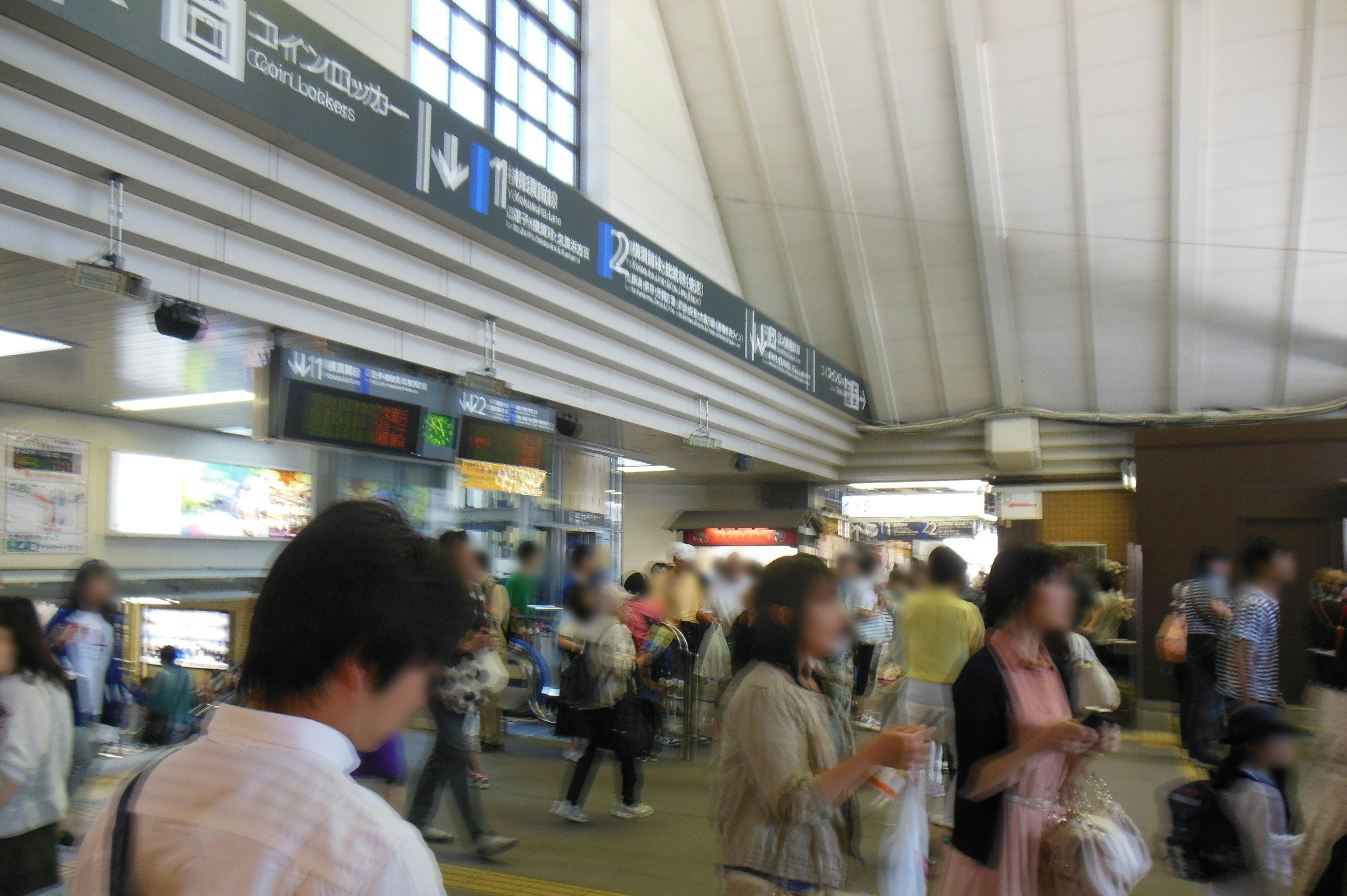 Crowded interior of a train station high ceilings and bright lighting