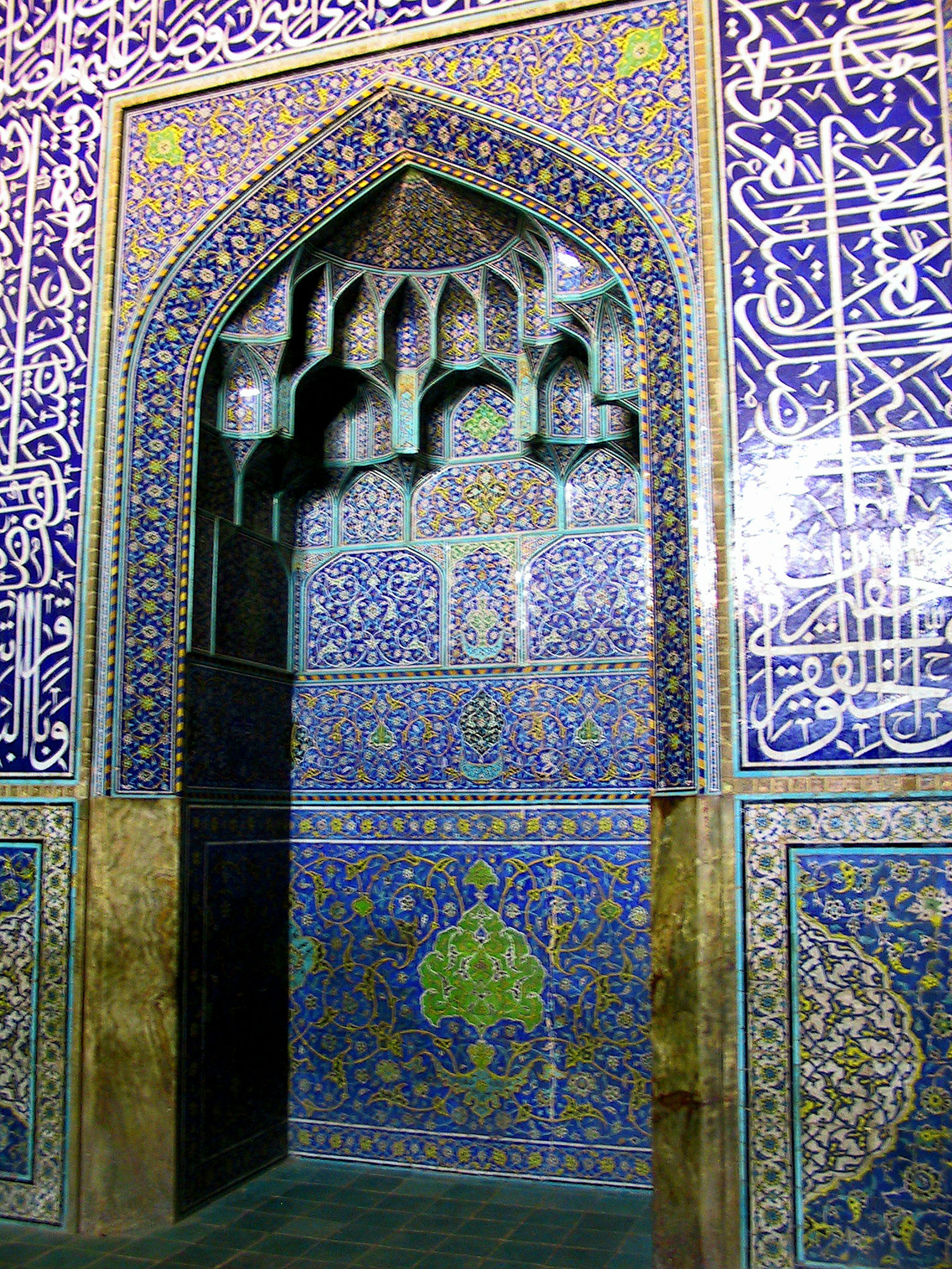 Beautifully tiled archway entrance with blue and green decorations on the walls