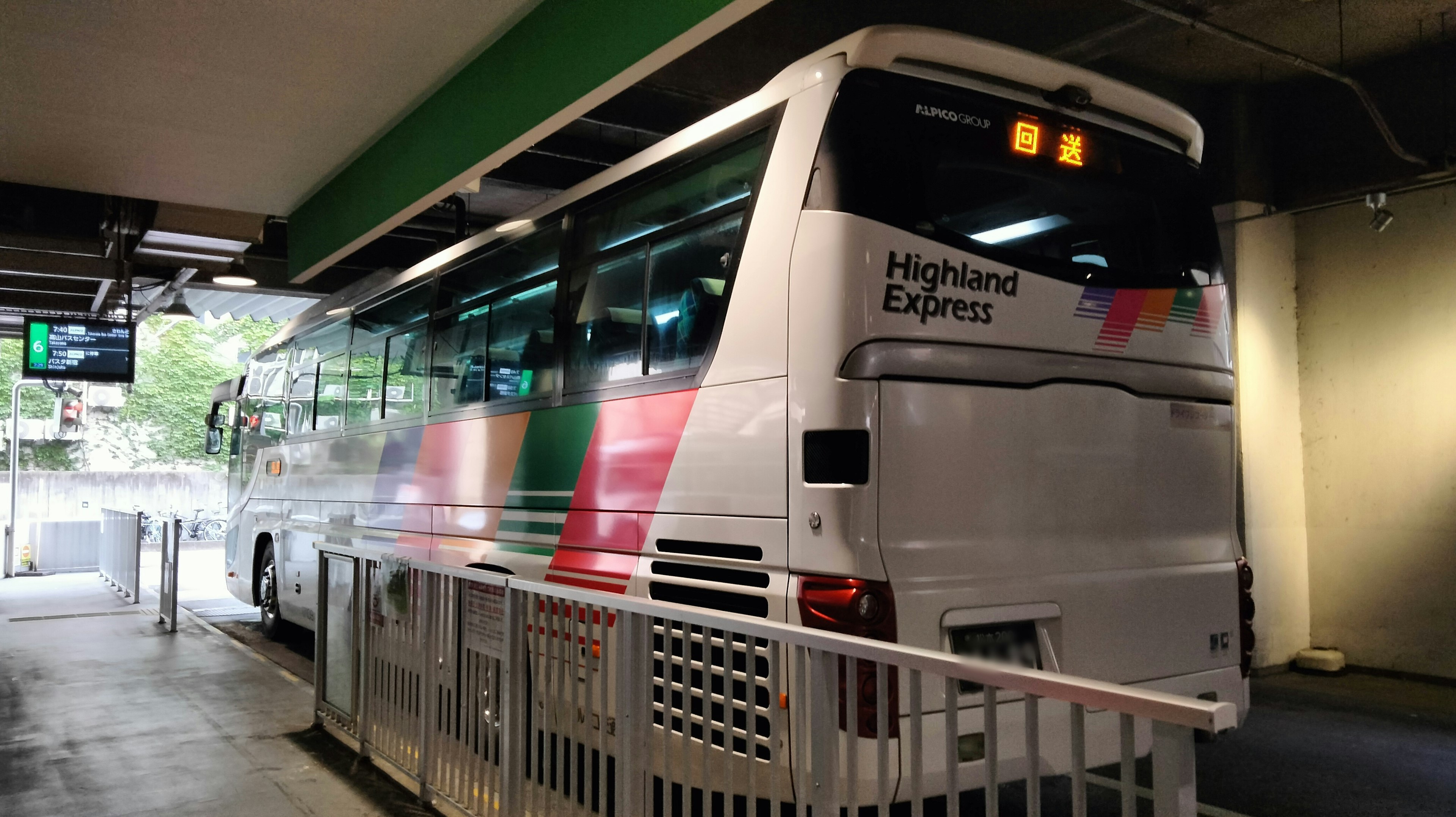 Rear view of a waiting highway bus at a terminal