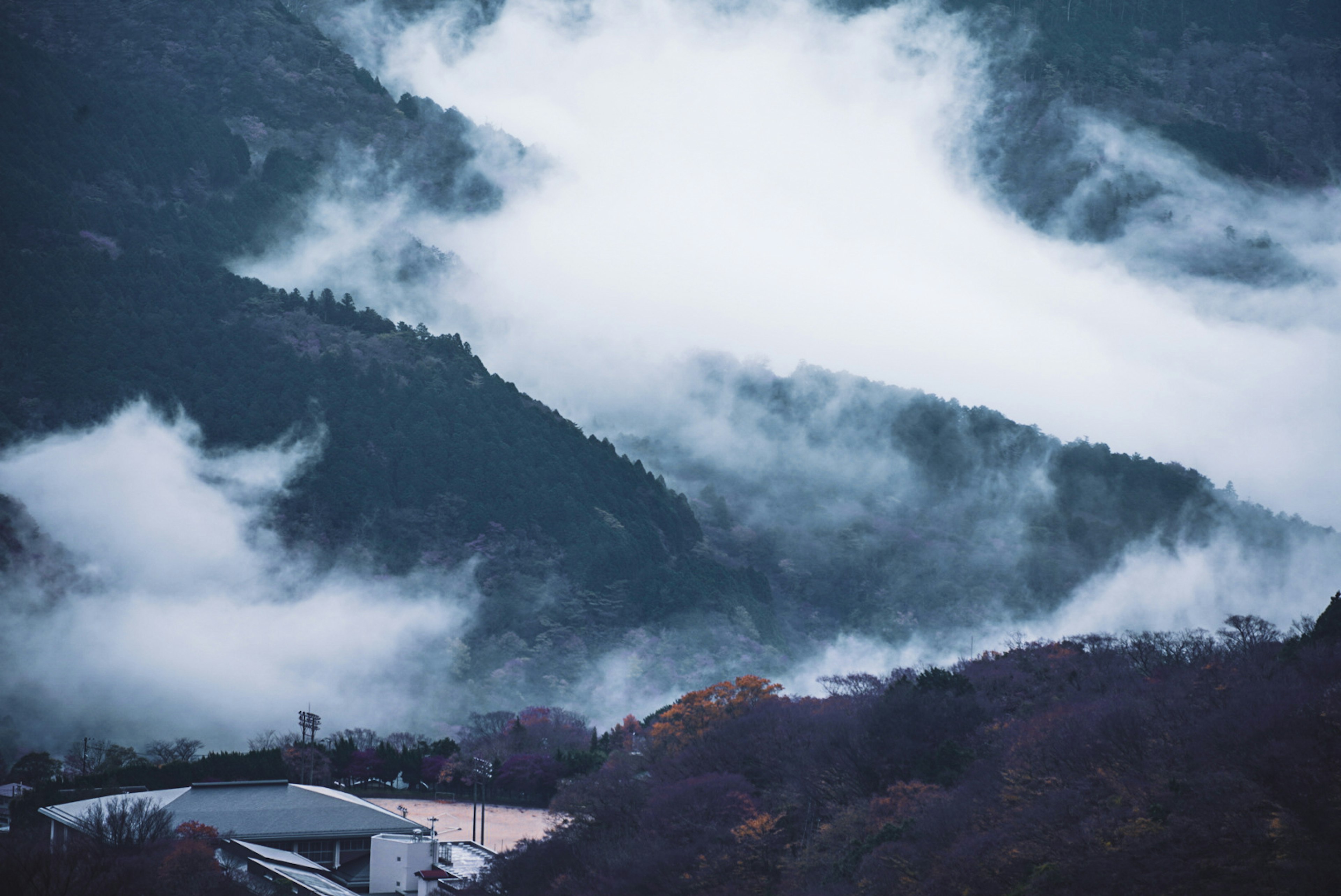 Mountains shrouded in mist with a tranquil landscape