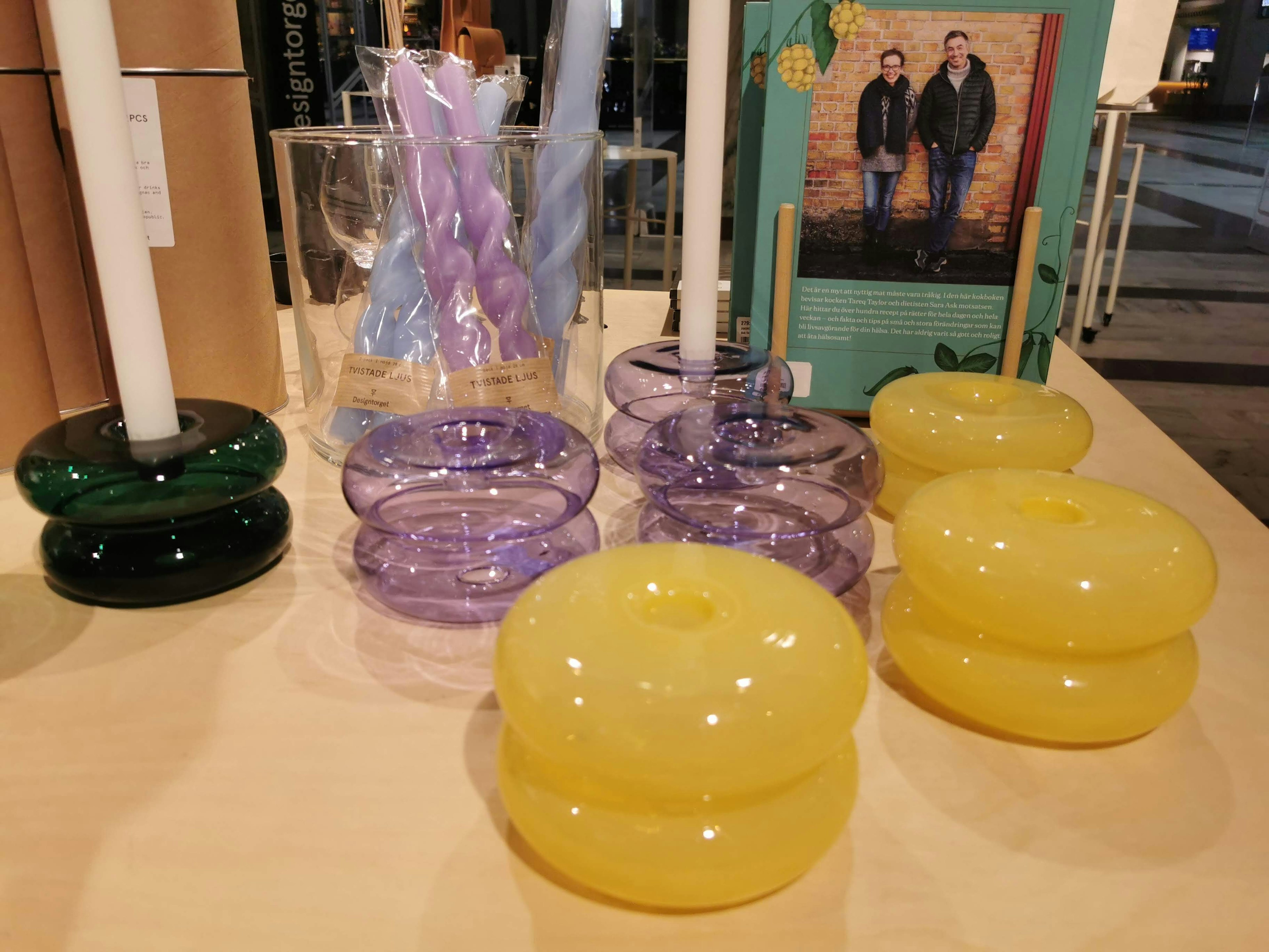 Colorful candle holders and candles displayed on a table