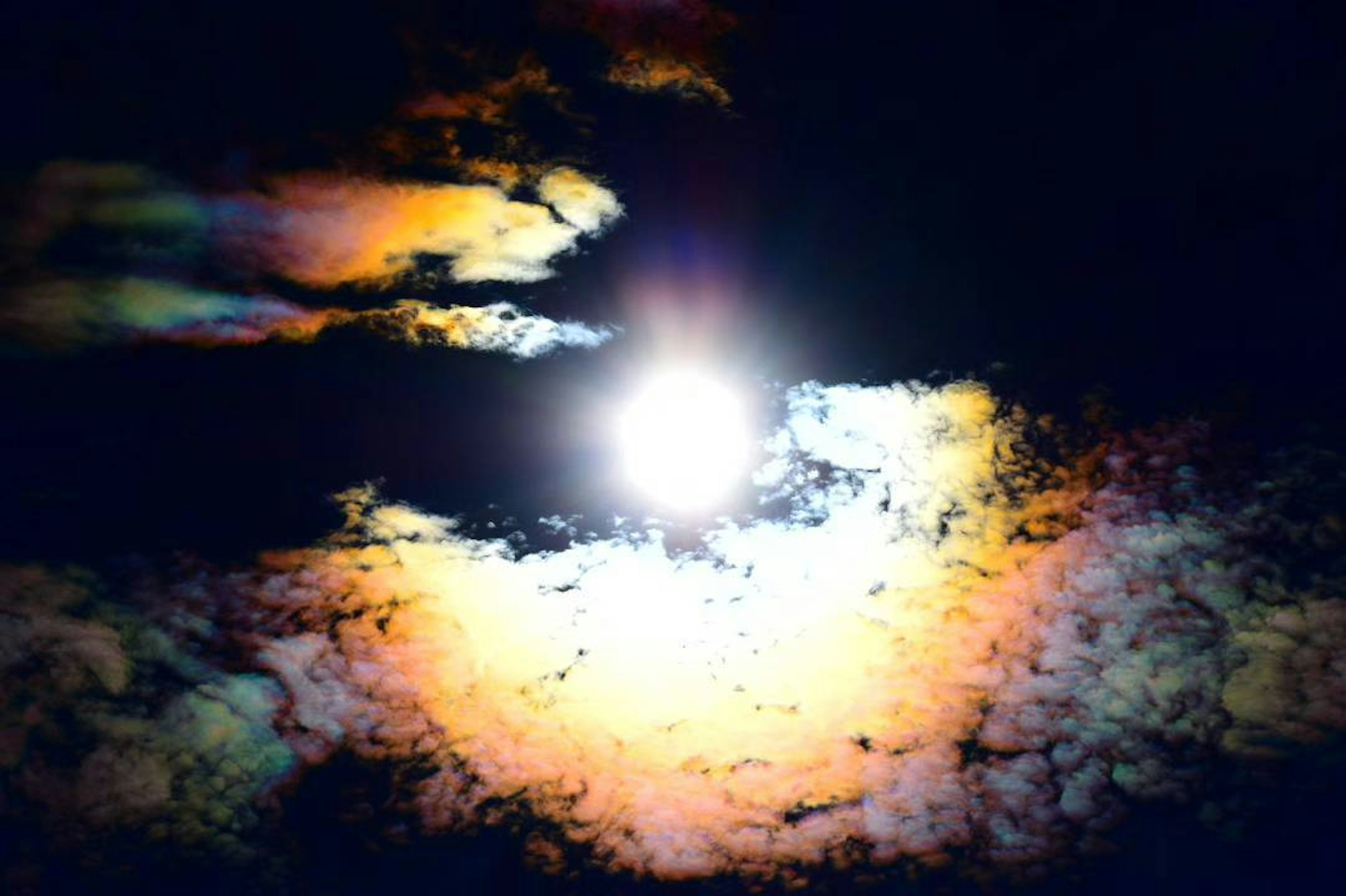 Un cielo surrealista con el sol rodeado de nubes coloridas