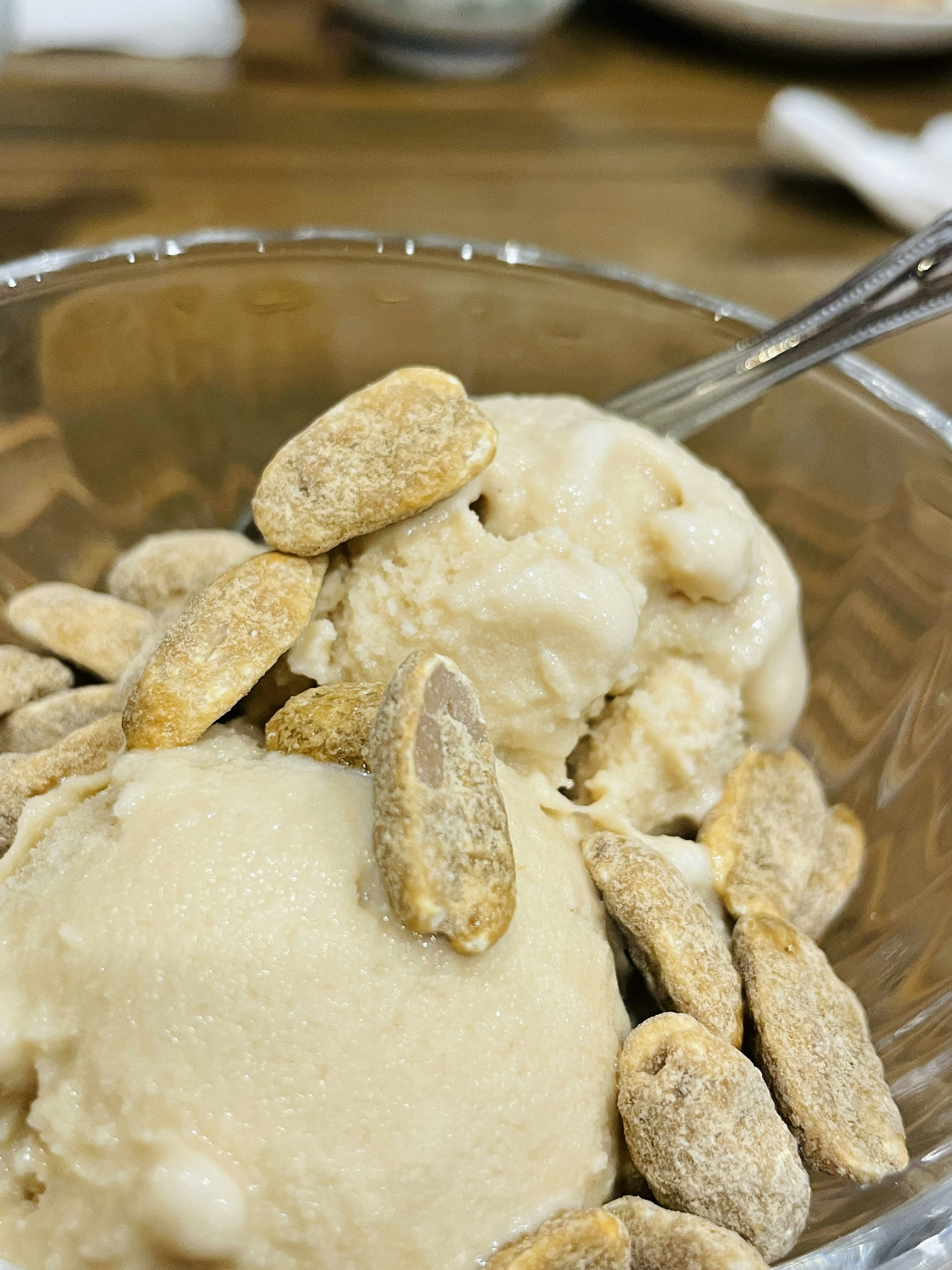 Bowl of ice cream topped with peanuts