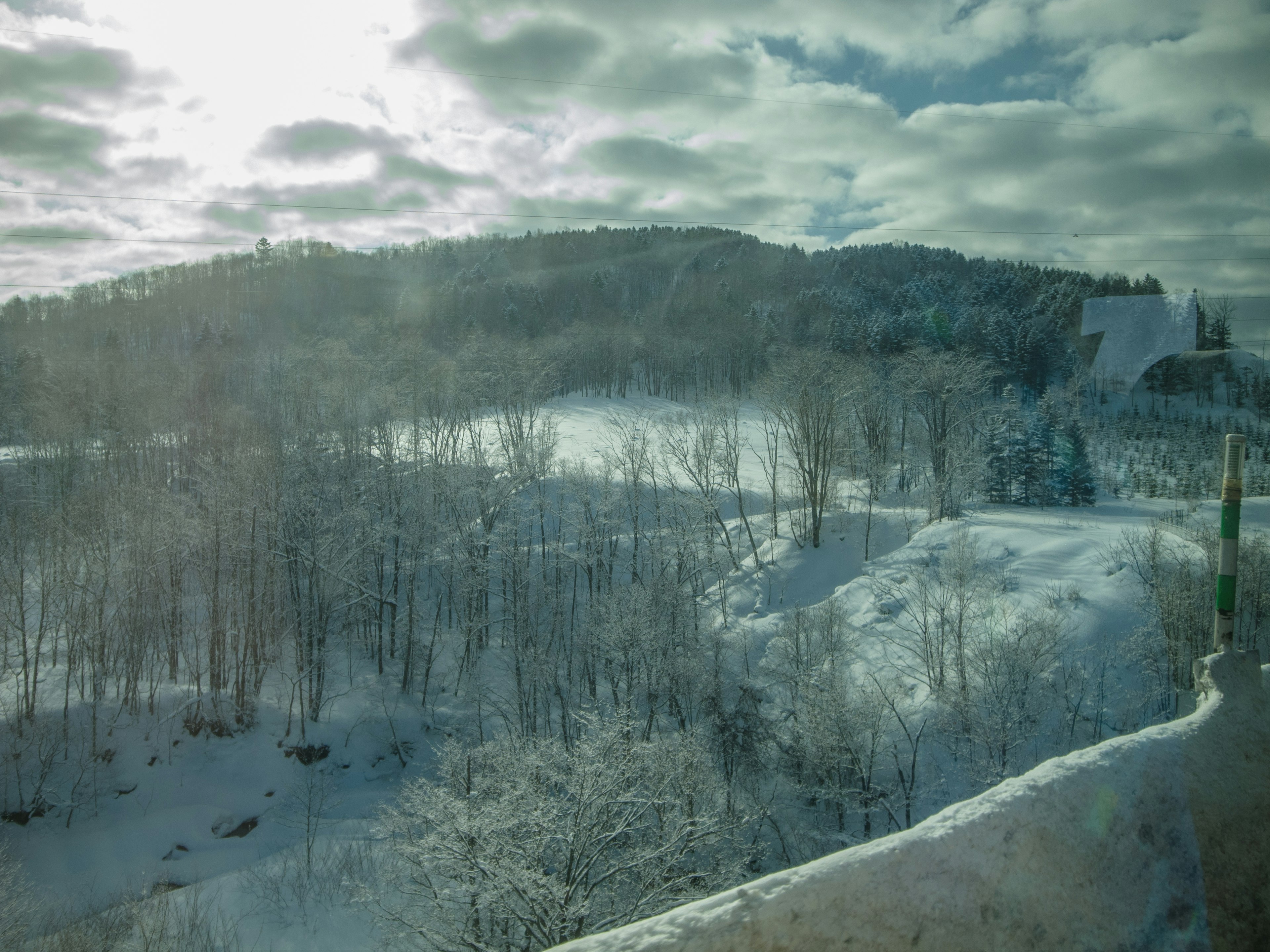 Snow-covered landscape with cloudy sky