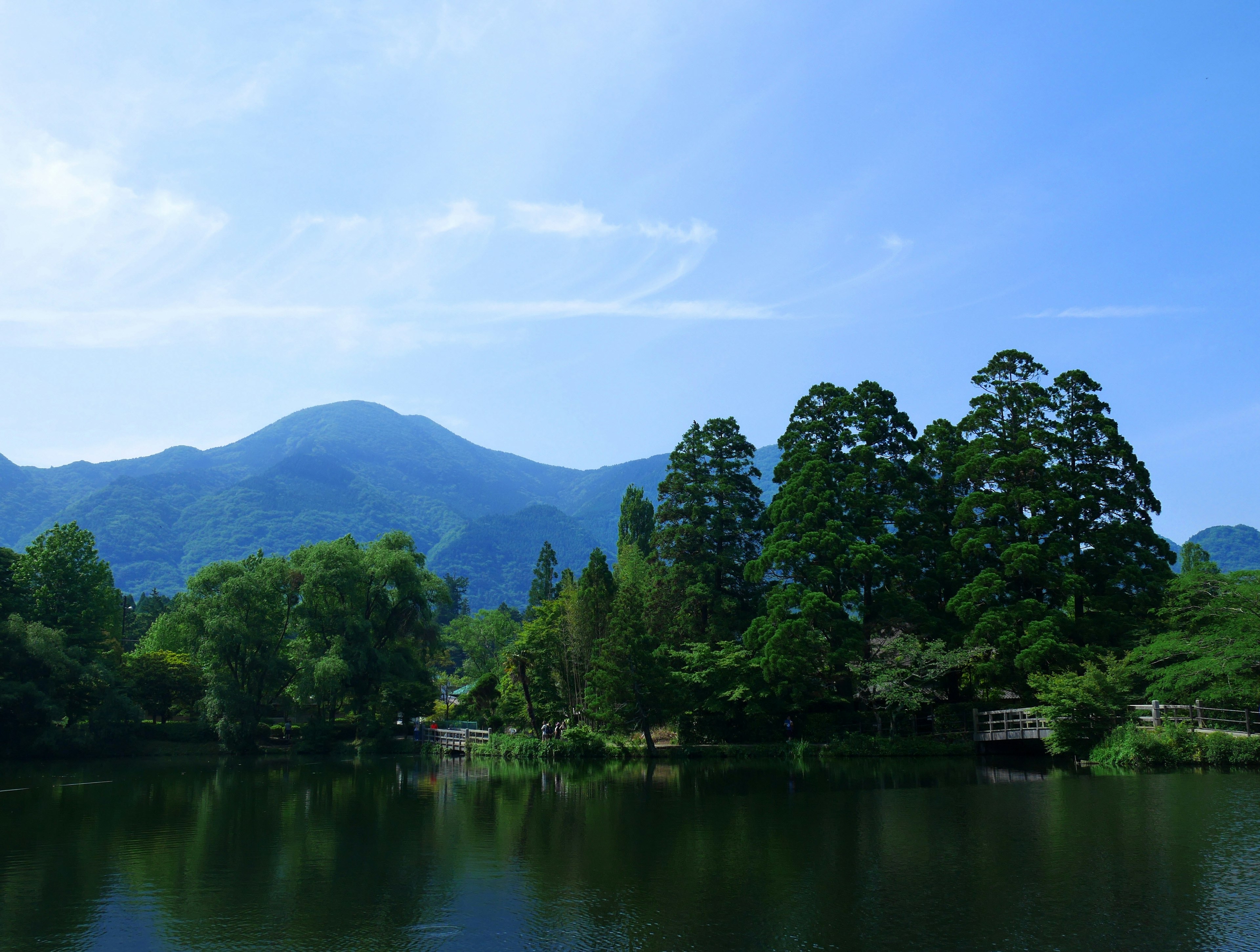 Danau tenang dengan pegunungan hijau