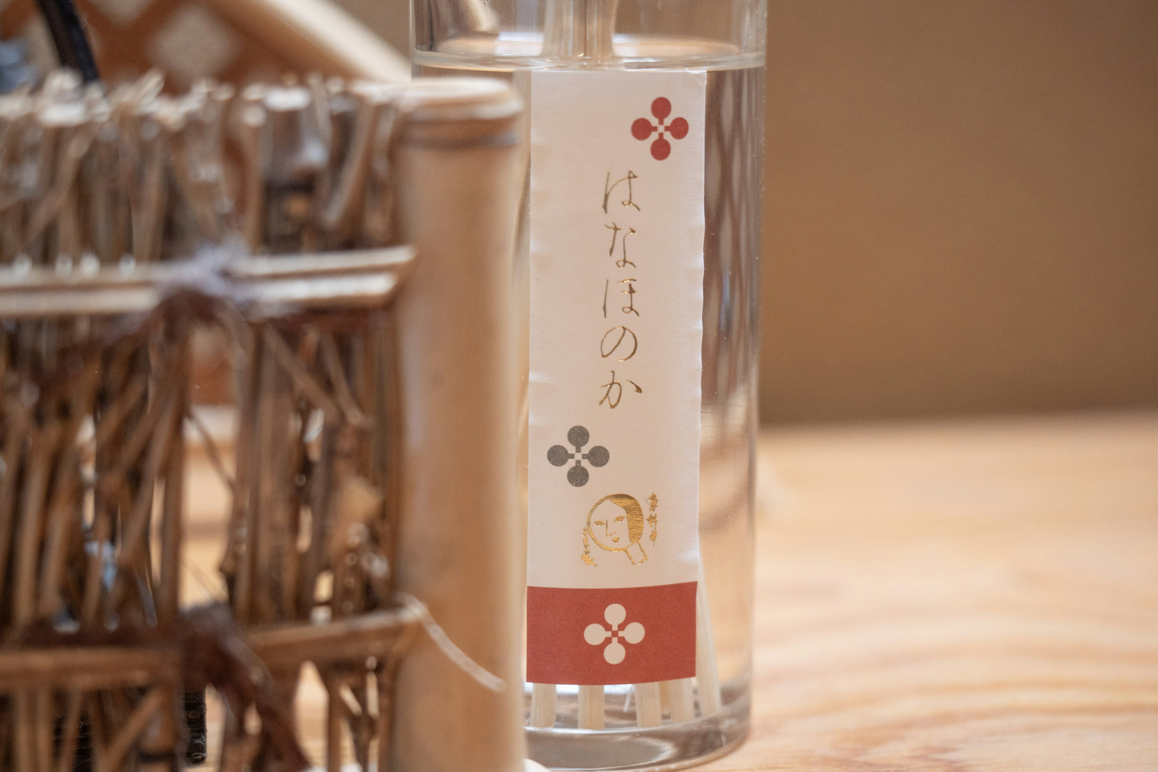 Clear bottle of Japanese sake with a decorative label