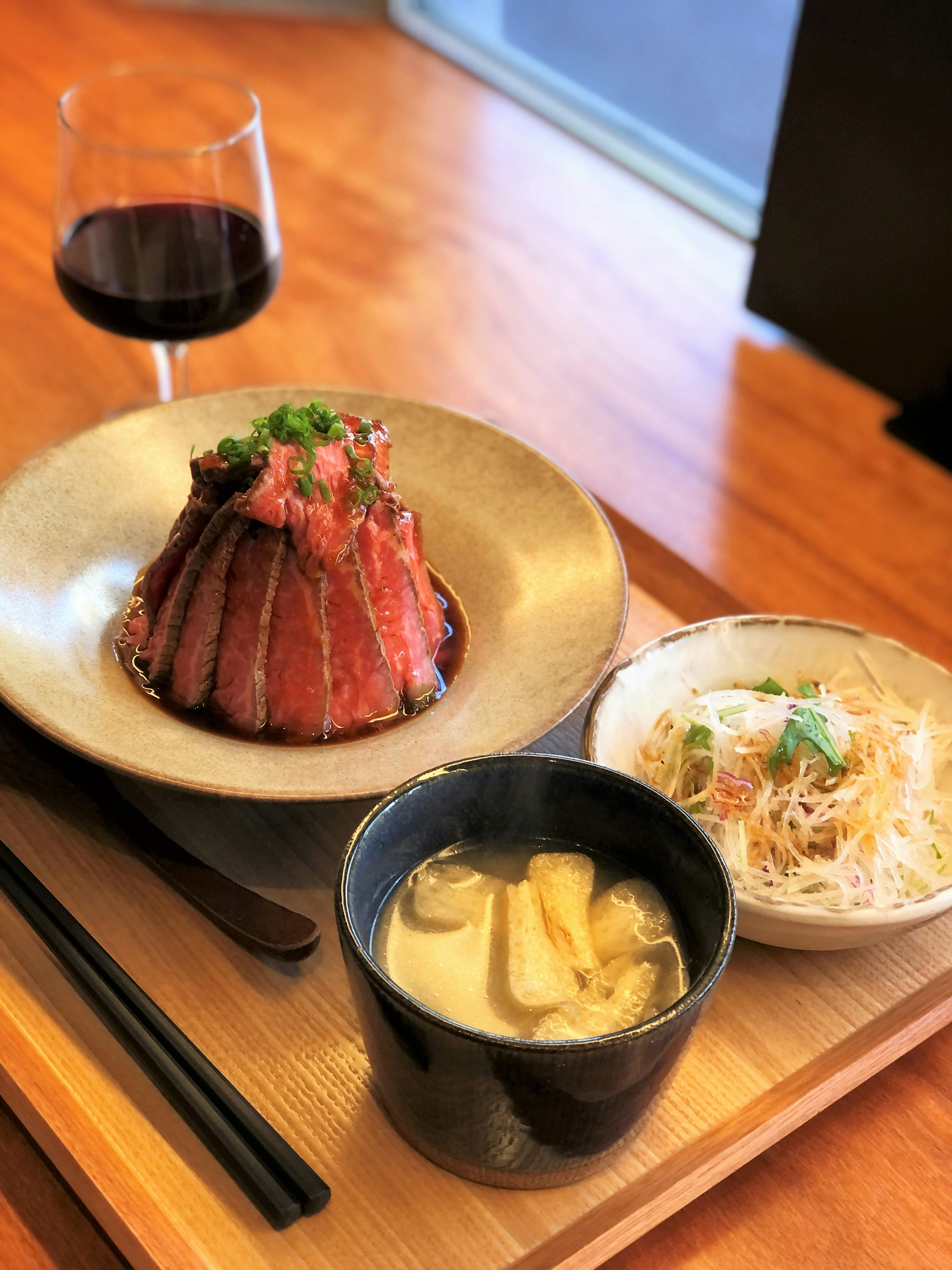 A beautifully arranged plate of Japanese cuisine featuring meat dish and side dishes