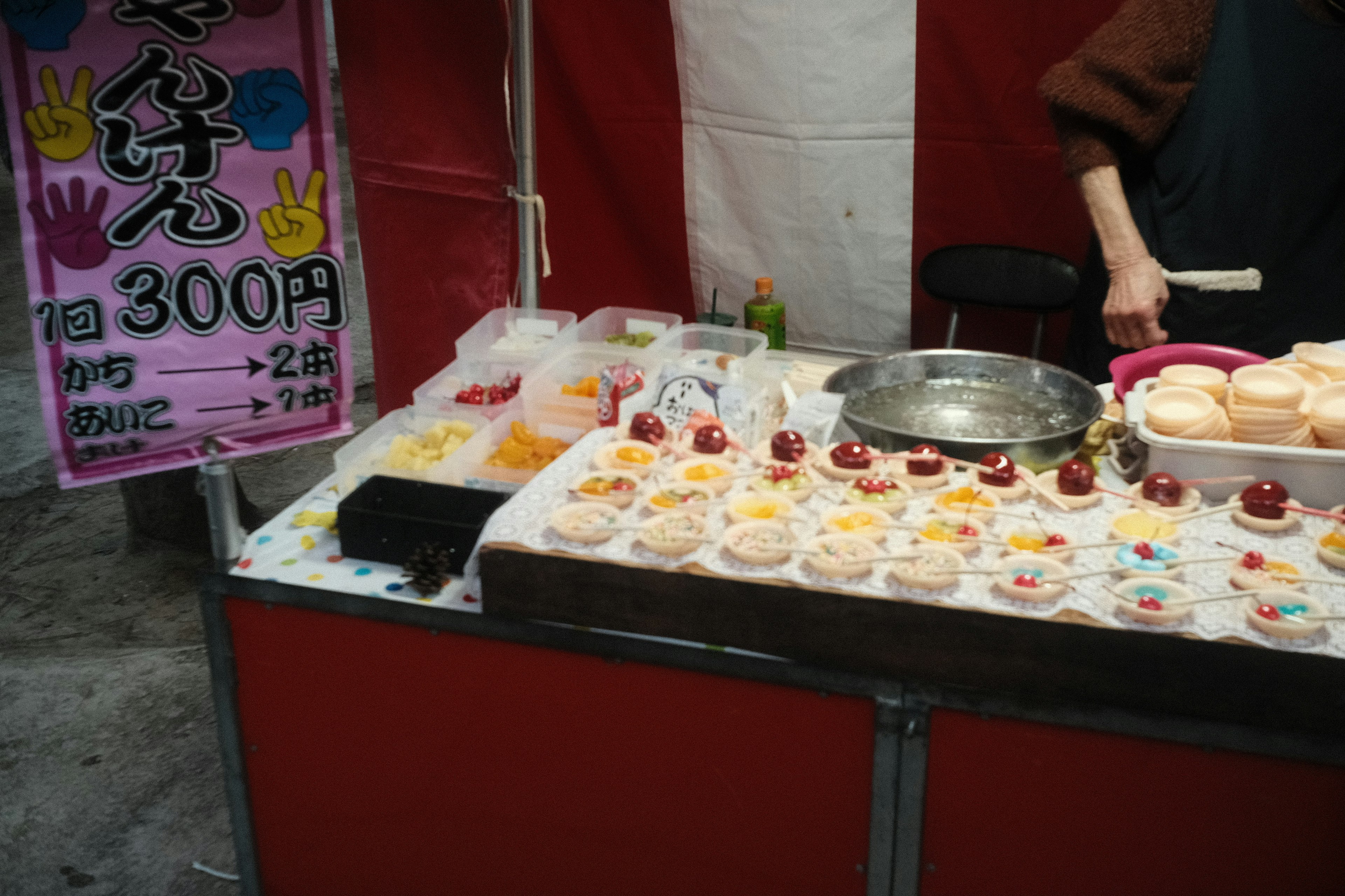 Colorful desserts displayed at a street vendor stall