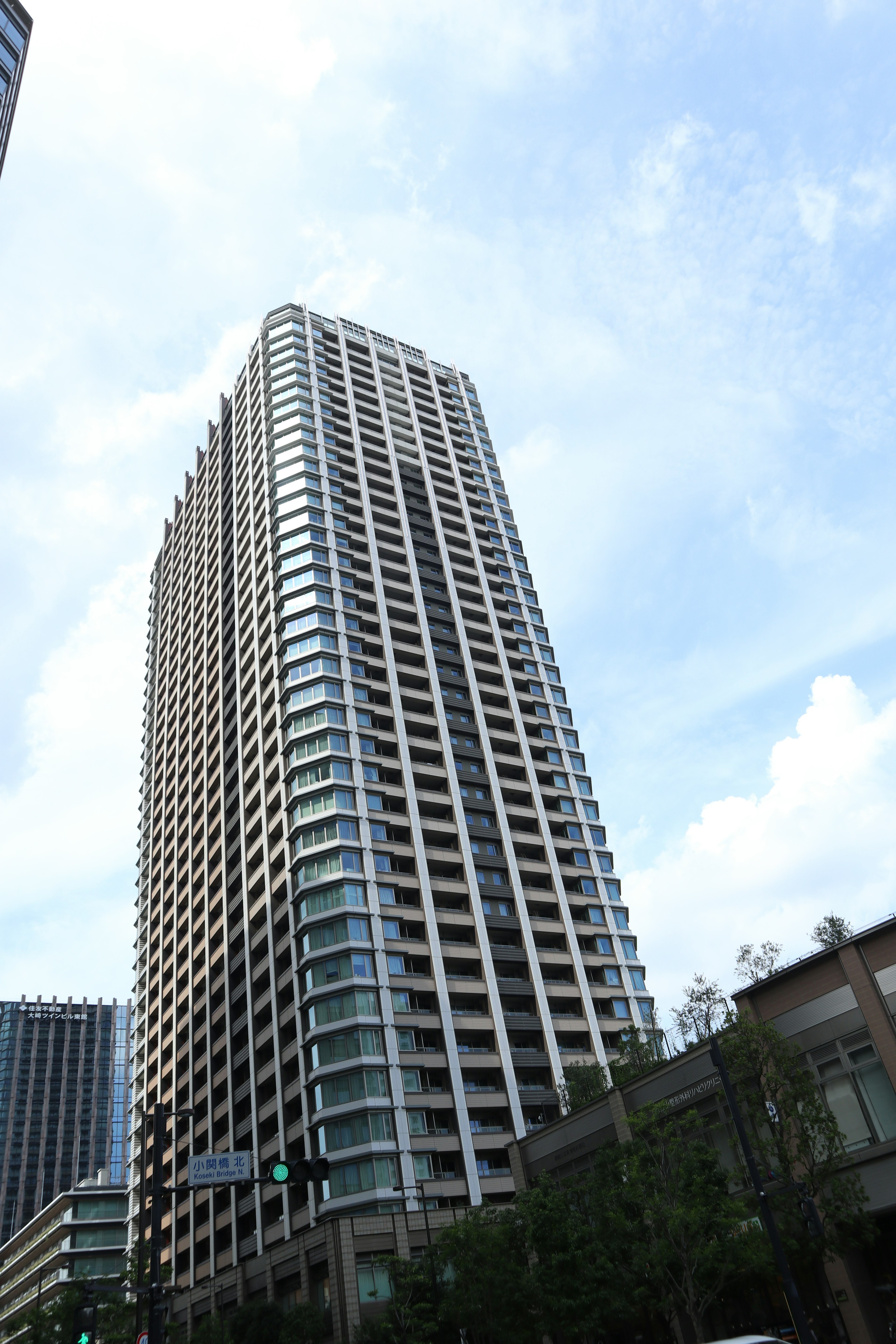 View of a tall building from below with a blue sky in the background