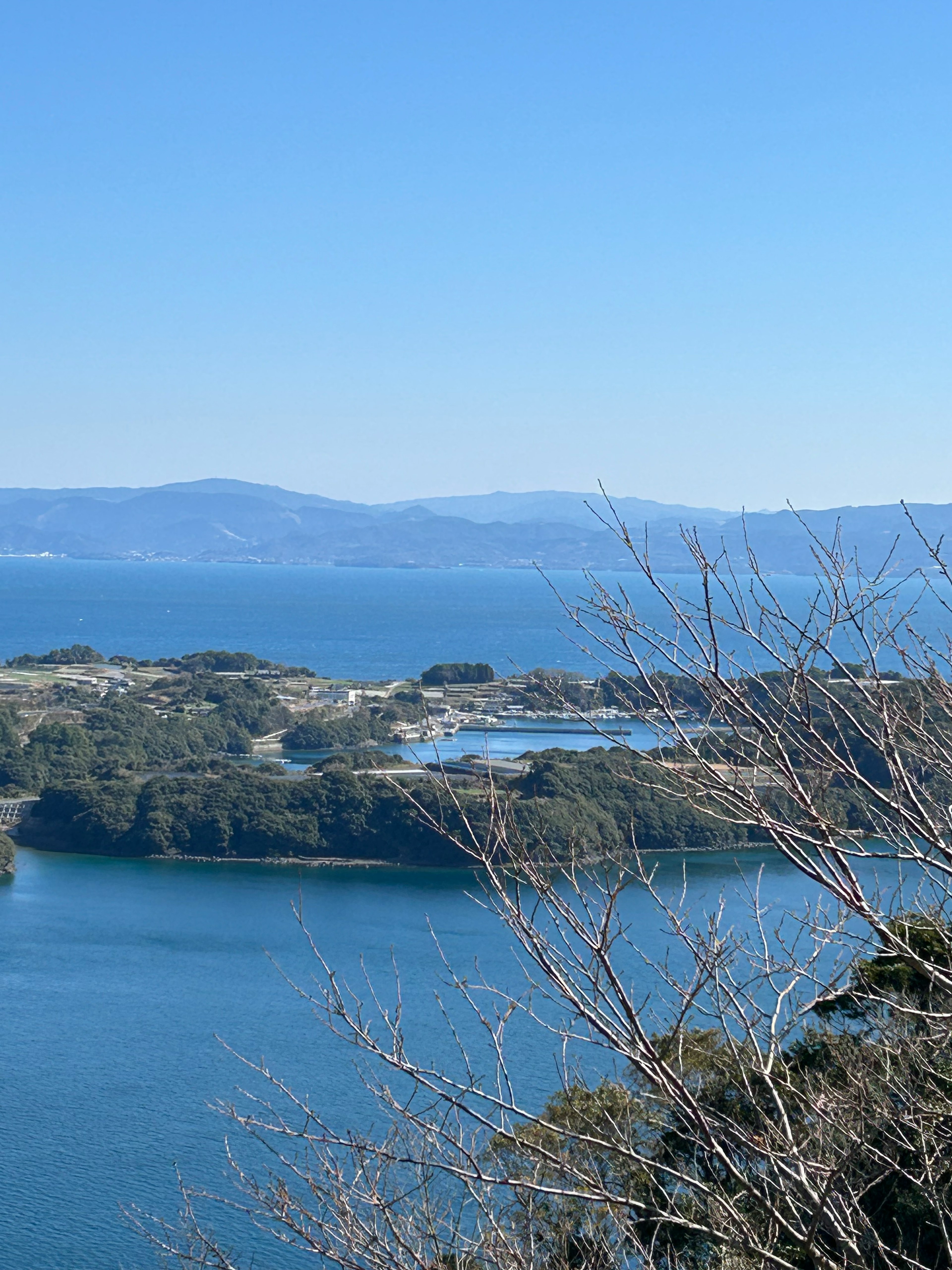 Scenic view of blue sea and islands with distant mountains